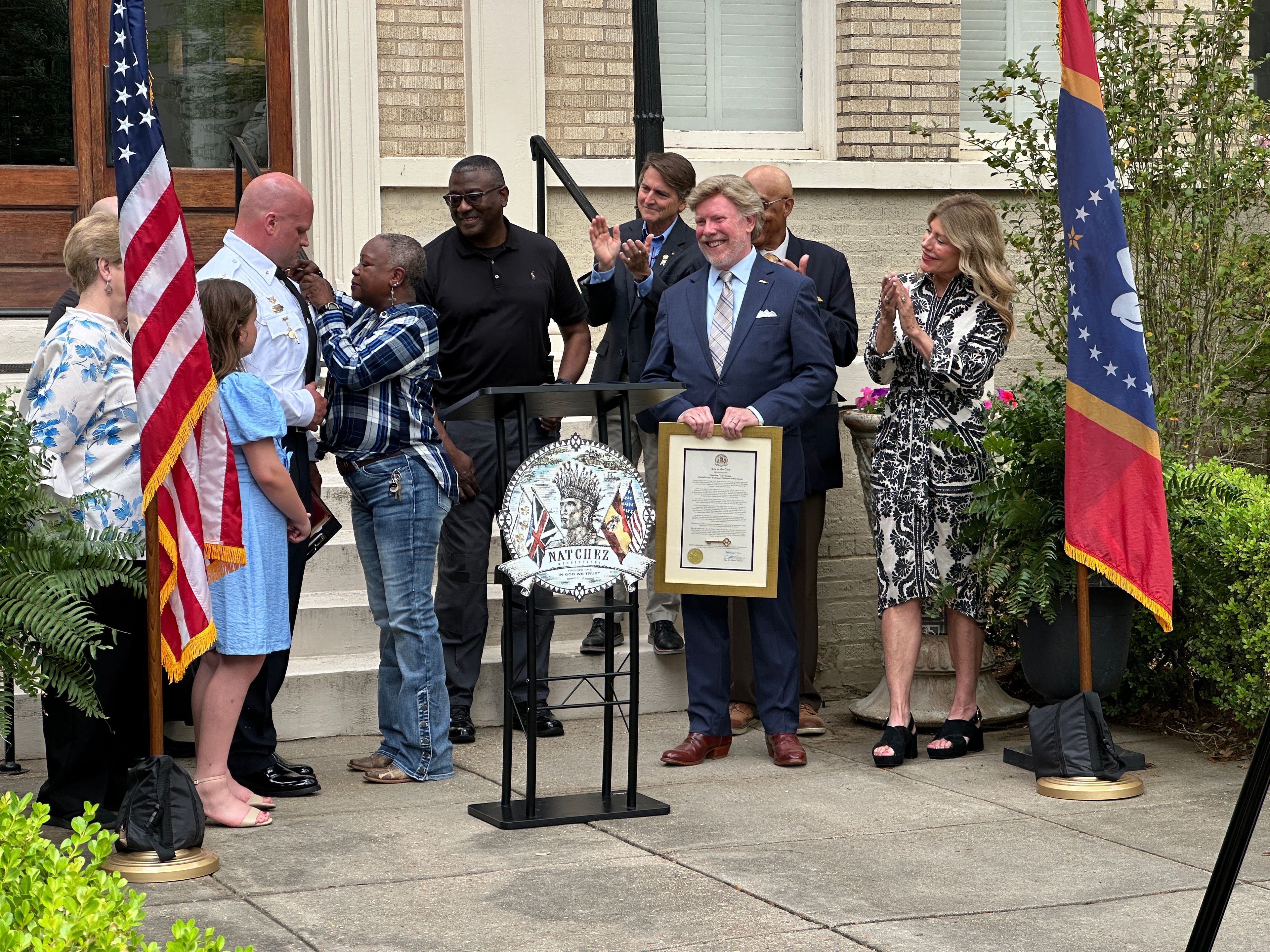 Former Natchez Police Chief Caroline ‘Cal’ Green pins her chief's badge onto new Natchez Police Chief Lee Best at his swearing in Wednesday morning at City Hall.