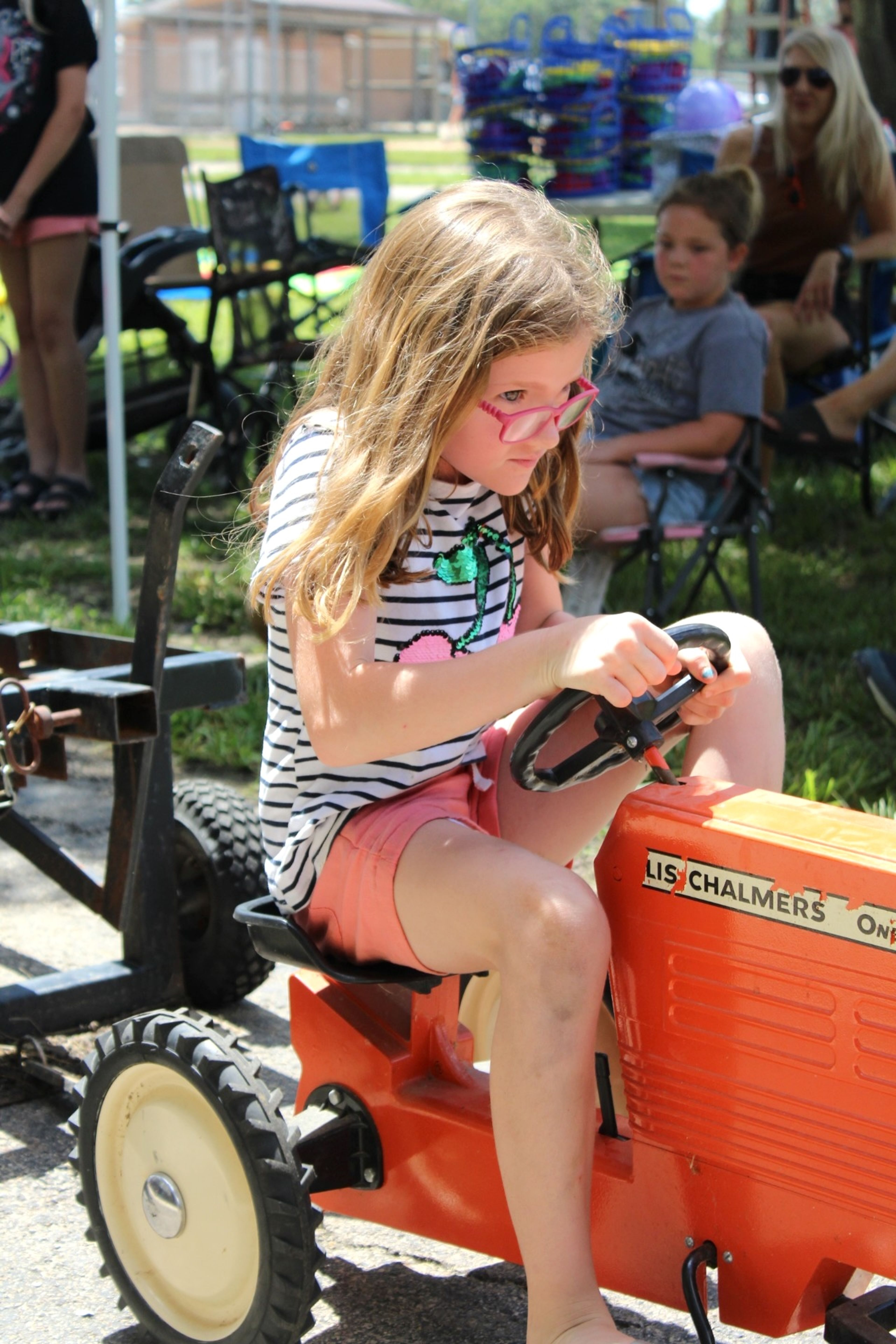 
Megan VanGennip steers her pedal tractor as she competes in the group for youngsters ages 7 and 8. She placed third in her age group.