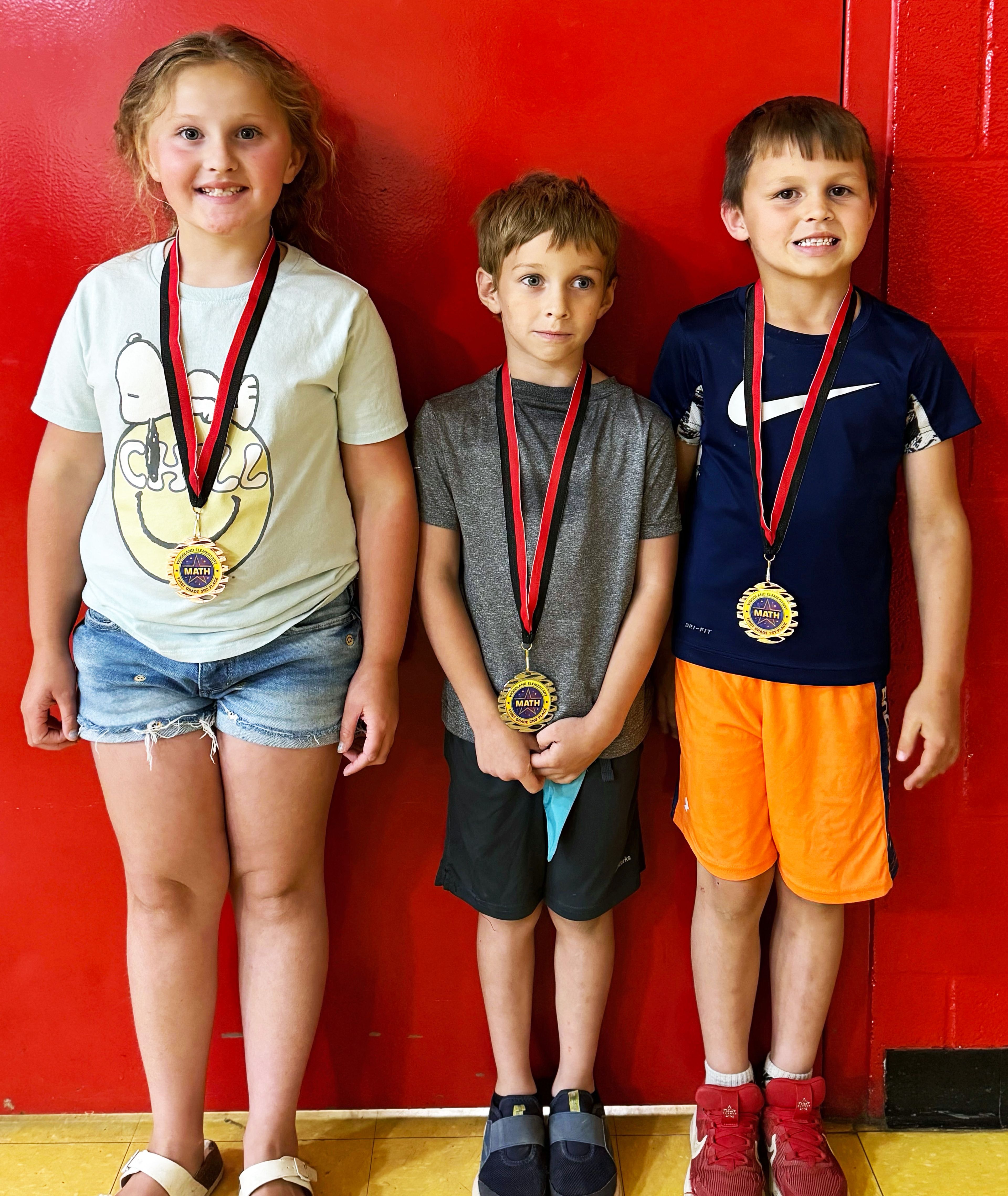 First-grade winners (from left) include Emma Moore, third place; Bentley Scherer, second place; and Kade Johnson, first place