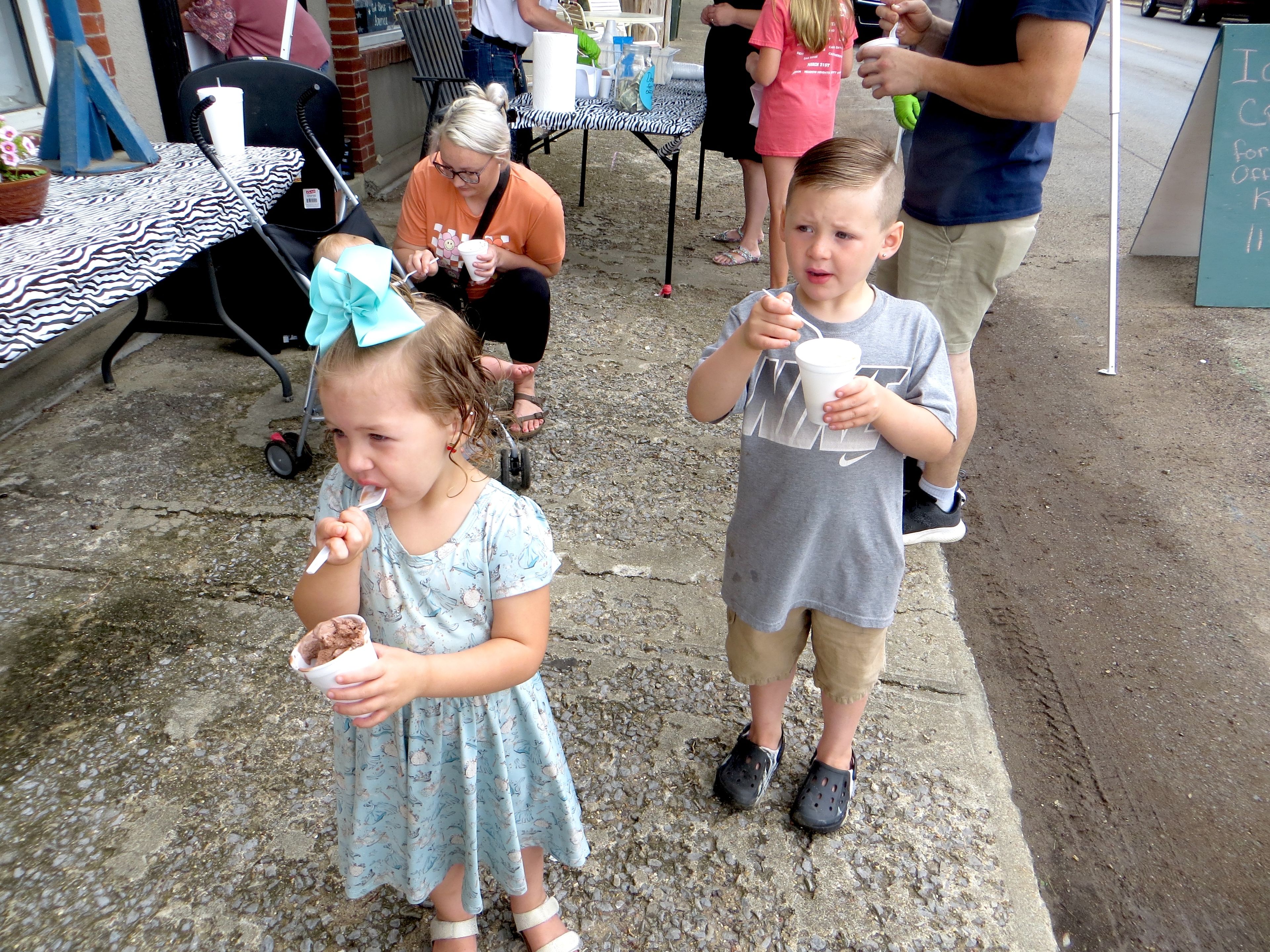 
Laken and River Cook of Marble Hill enjoy ice cream while their mother, Taylor Cook, offers baby Rowdy a few bites.