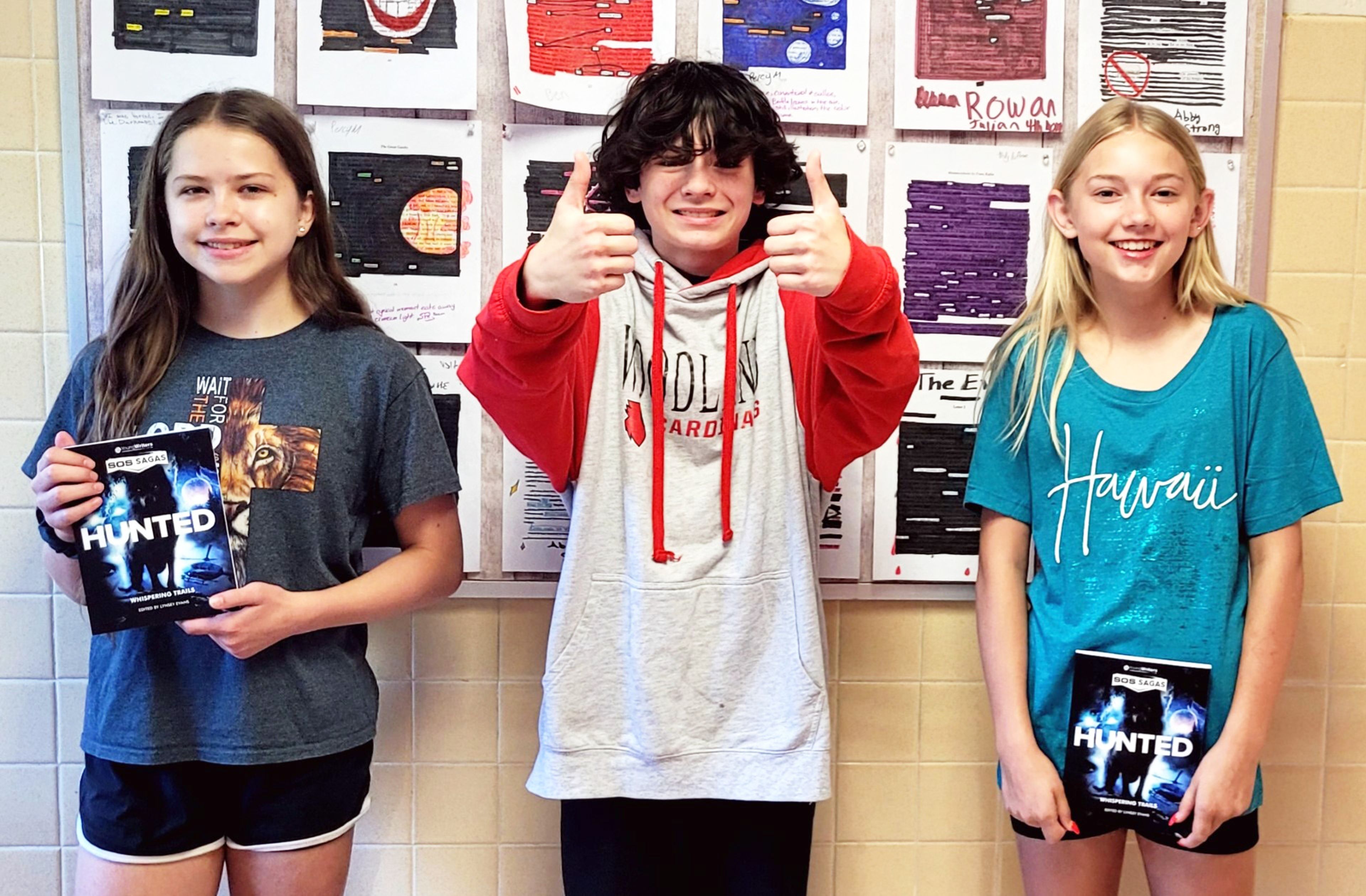 Woodland seventh graders Karissa Green, River Fain and Alexsa VanGennip are happy to be published authors. Their work was published in the Young Writers book, ‘SOS Sagas: Hunted.’