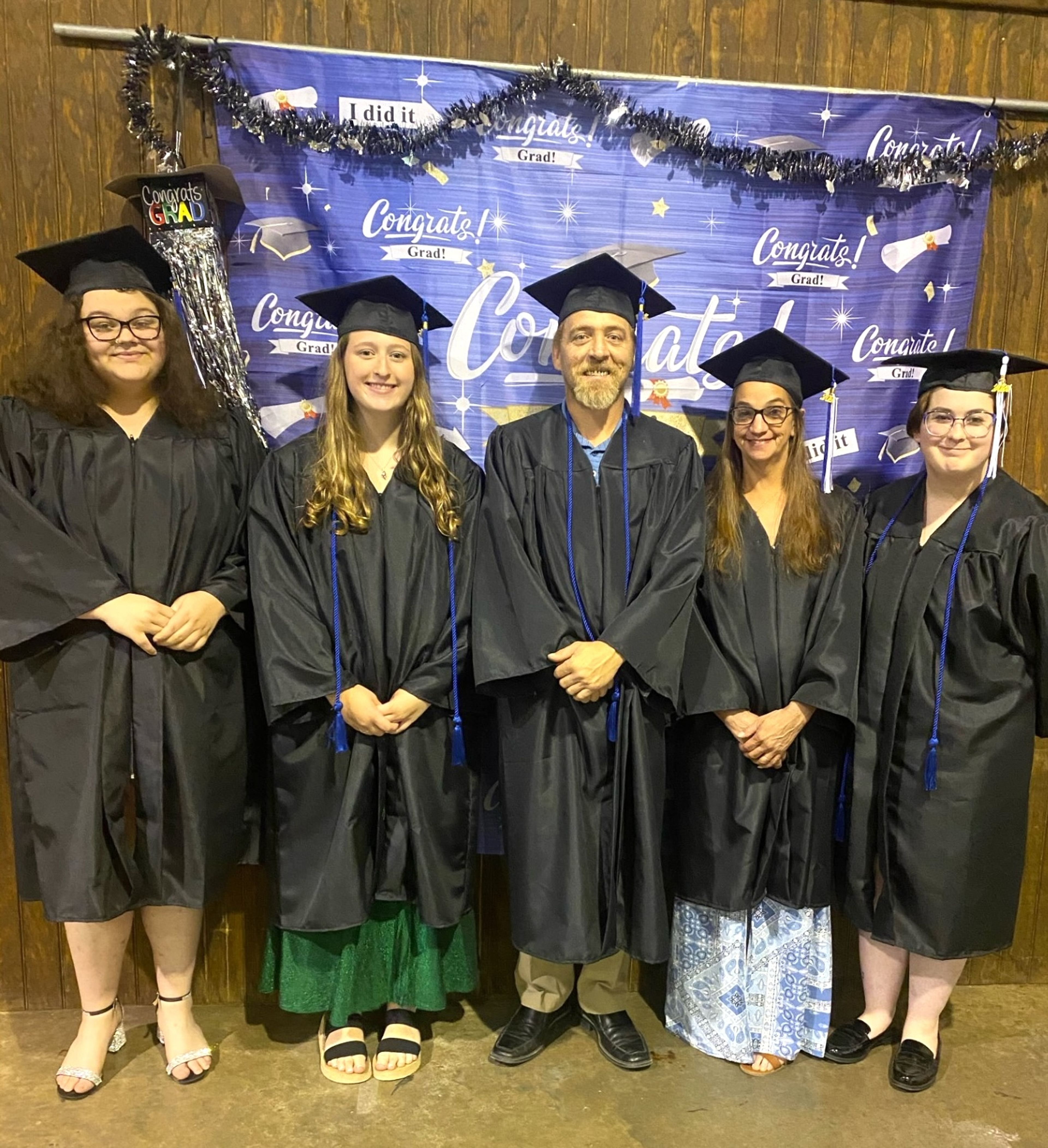 
Autumn Montgomery, Kayedy Ross, husband-and-wife duo Chris and Pam Masters, and Samantha Plaza-Bacon don their caps and gowns earlier this month for the 2024 HiSET graduation in Bollinger County. (Not pictured are HiSET graduates Quentin Smith and Katie Burton.) Chris Masters, Ross and Plaza-Bacon all graduated with honors with a score over 80 points. HiSET classes will start again in August. Classes are from 5 to 8 p.m. Monday and Tuesday at Bollinger County Library in Marble Hill. Debbie Lincoln is the teacher. For more information, contact Cape AEL at (573) 334-3669.
