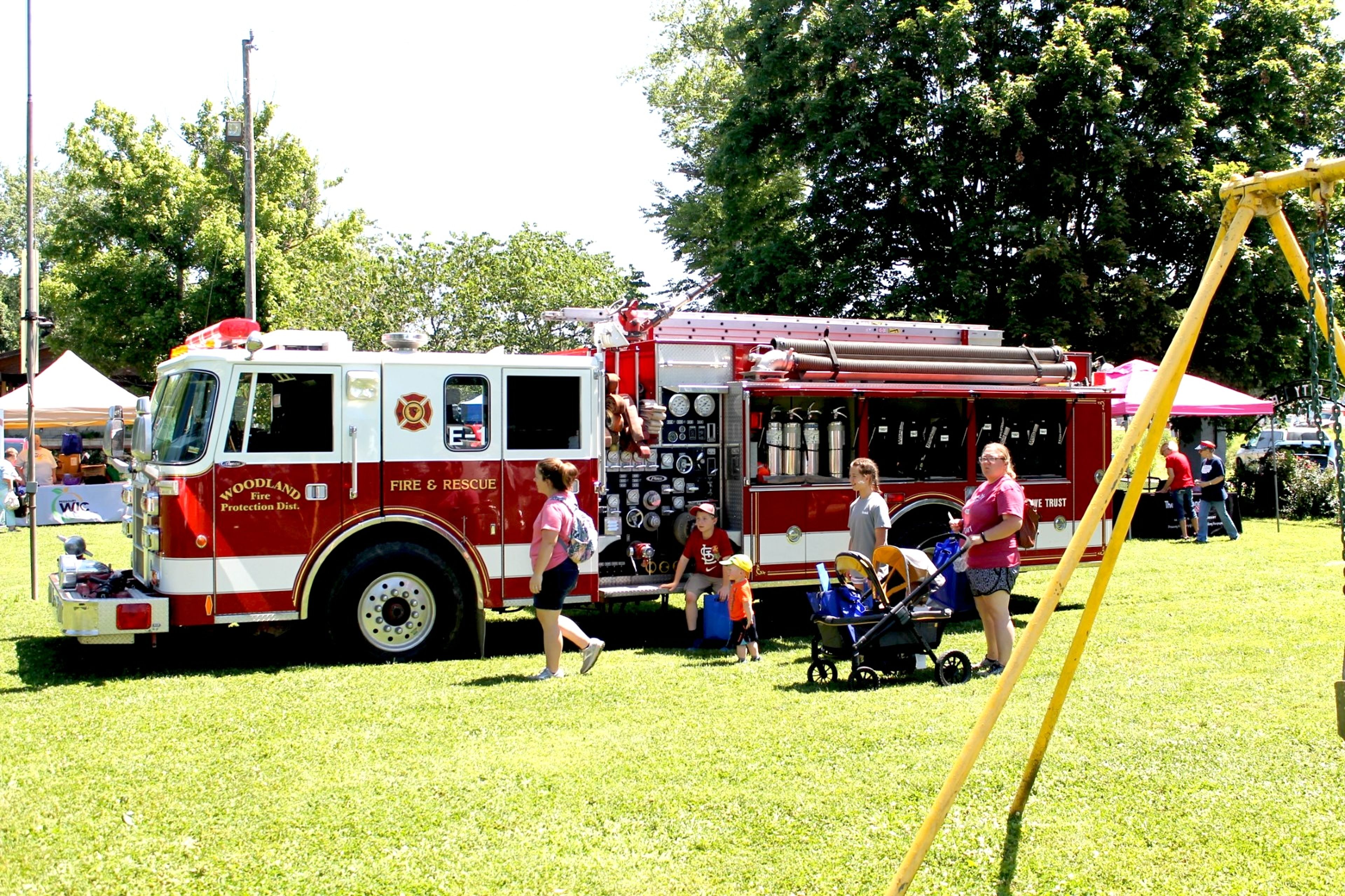Juanita Welker's family checks out Woodland Fire Protection District's fire truck during the resource fair. Juanita Welker is administrator of Bollinger County Health Center.
