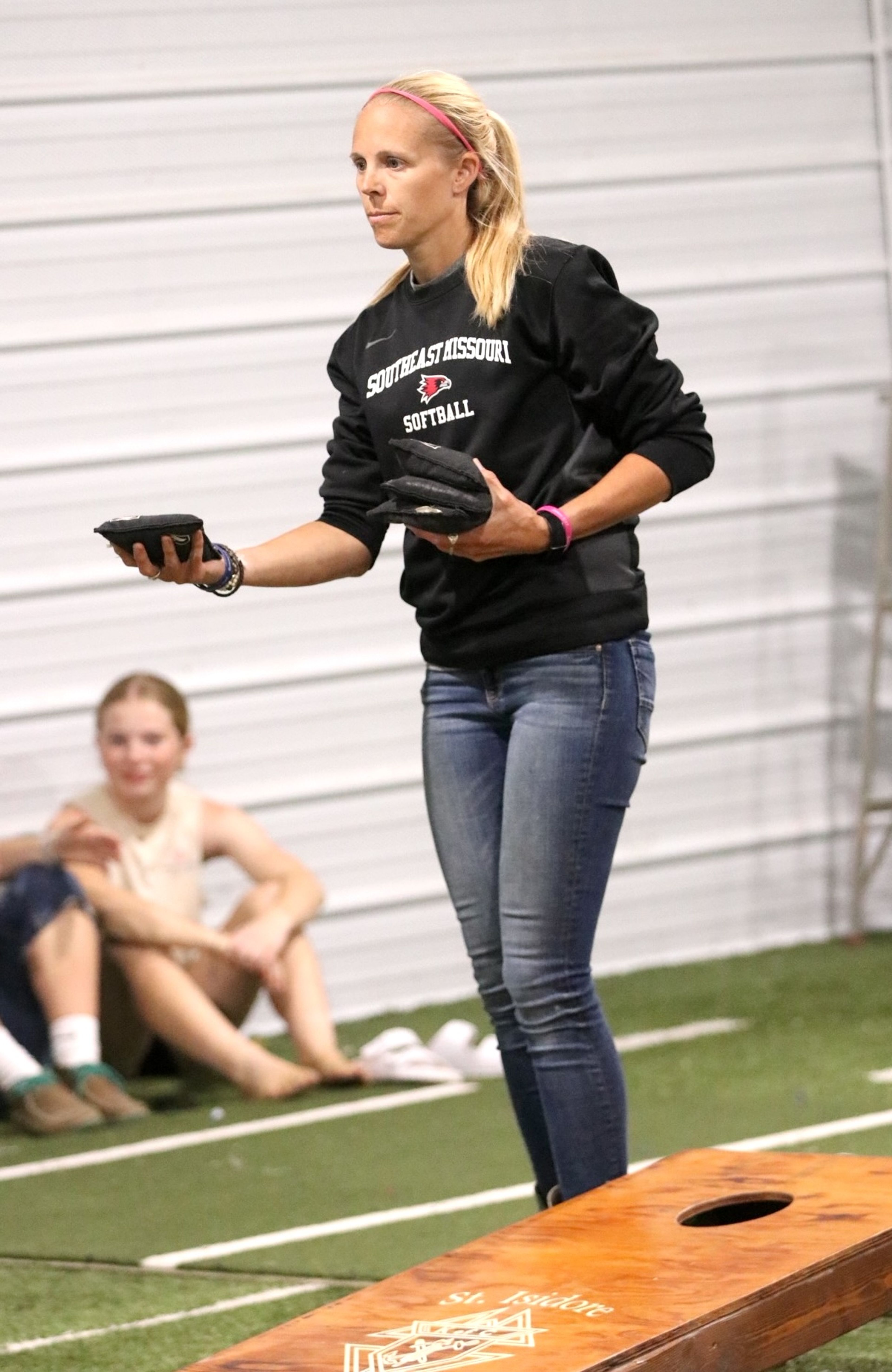 
Holly Hoesli prepares to throw a corn bag during the corn hole competition inside the KC multipurpose building.