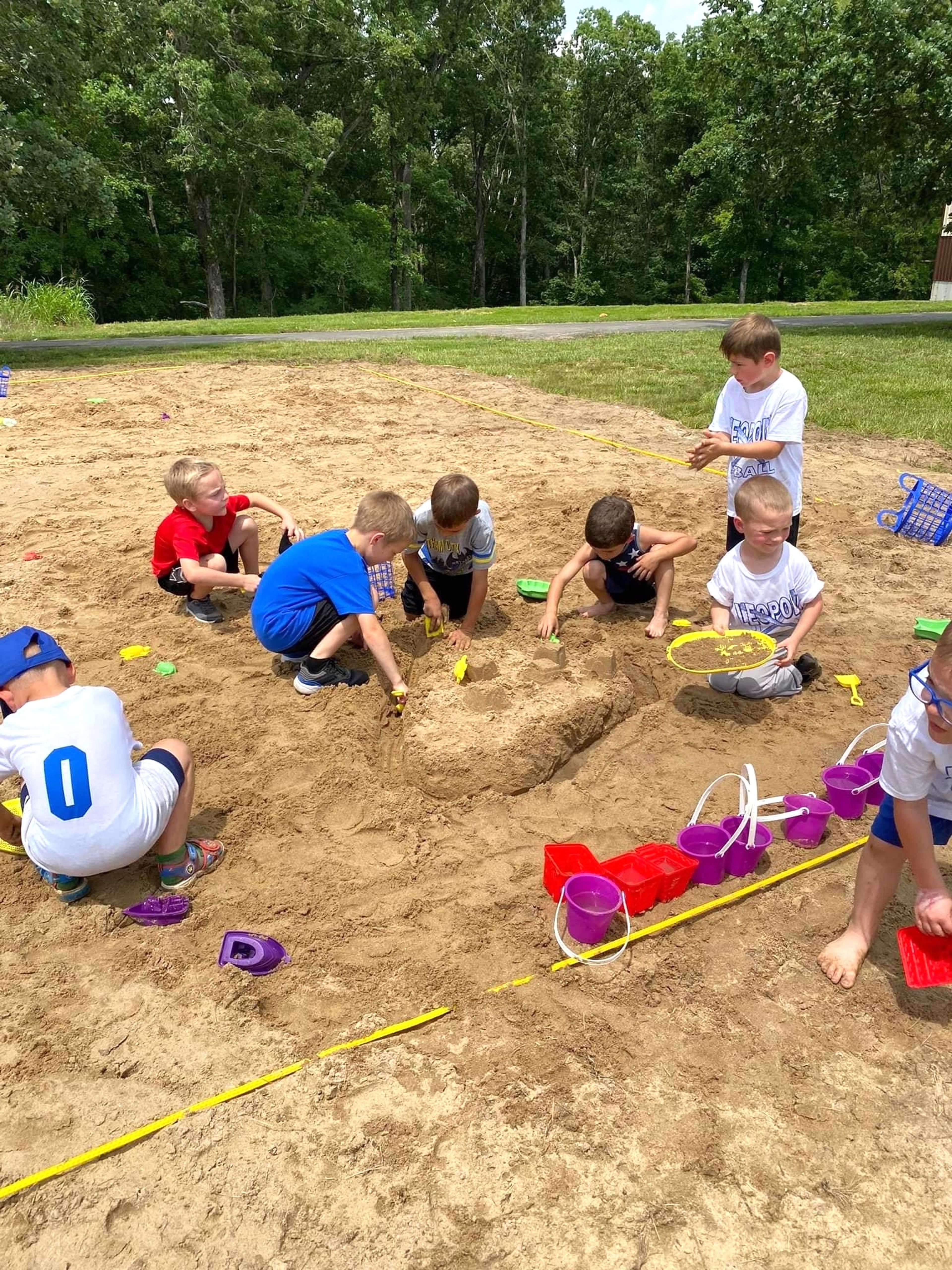 
Several children take advantage of the sand toys and work together to build a sand castle masterpiece.