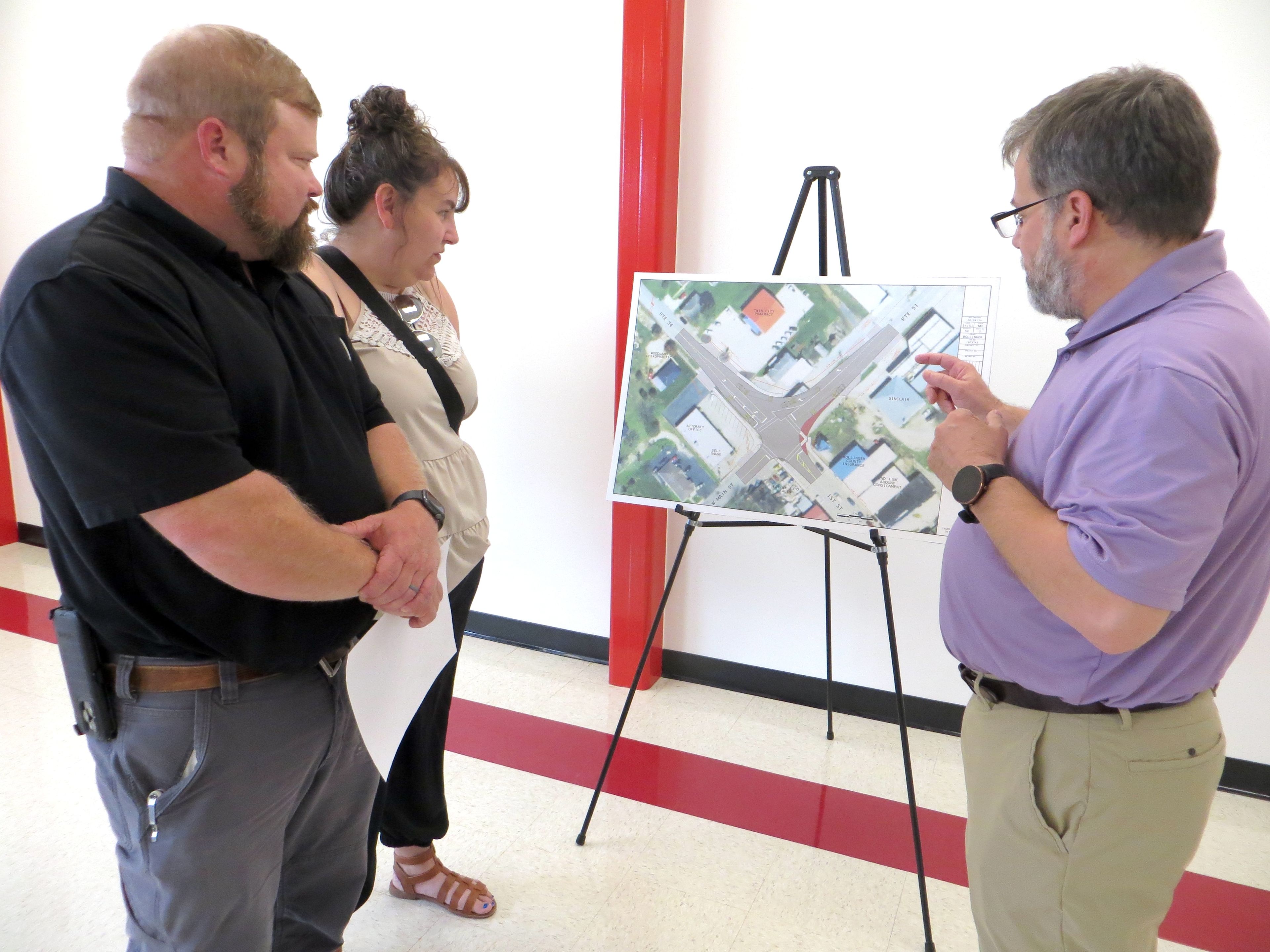 Missouri Department of Transportation project manager Tim Pickett talks to Marble Hill Mayor Trey Wiginton and Bollinger County Chamber of Commerce president Becky Wiginton about the plans to improve the south Route 34/51 intersection in Marble Hill. An open house-style public meeting was Monday in the FEMA building at Woodland School, where visitors could stop by any time from 5 to 7 p.m. to discuss the details of the project with MoDOT officials. The project includes upgrading the existing Route 34/51 intersection to improve turning movements for tractor trailers and other large vehicles, and adding a section of sidewalk to connect to the existing pedestrian facility. The project is expected to be let in February, and construction could begin as early as next spring. Work will be staged to allow the intersection to remain open with minor detours as needed. Completion is anticipated in November 2025.