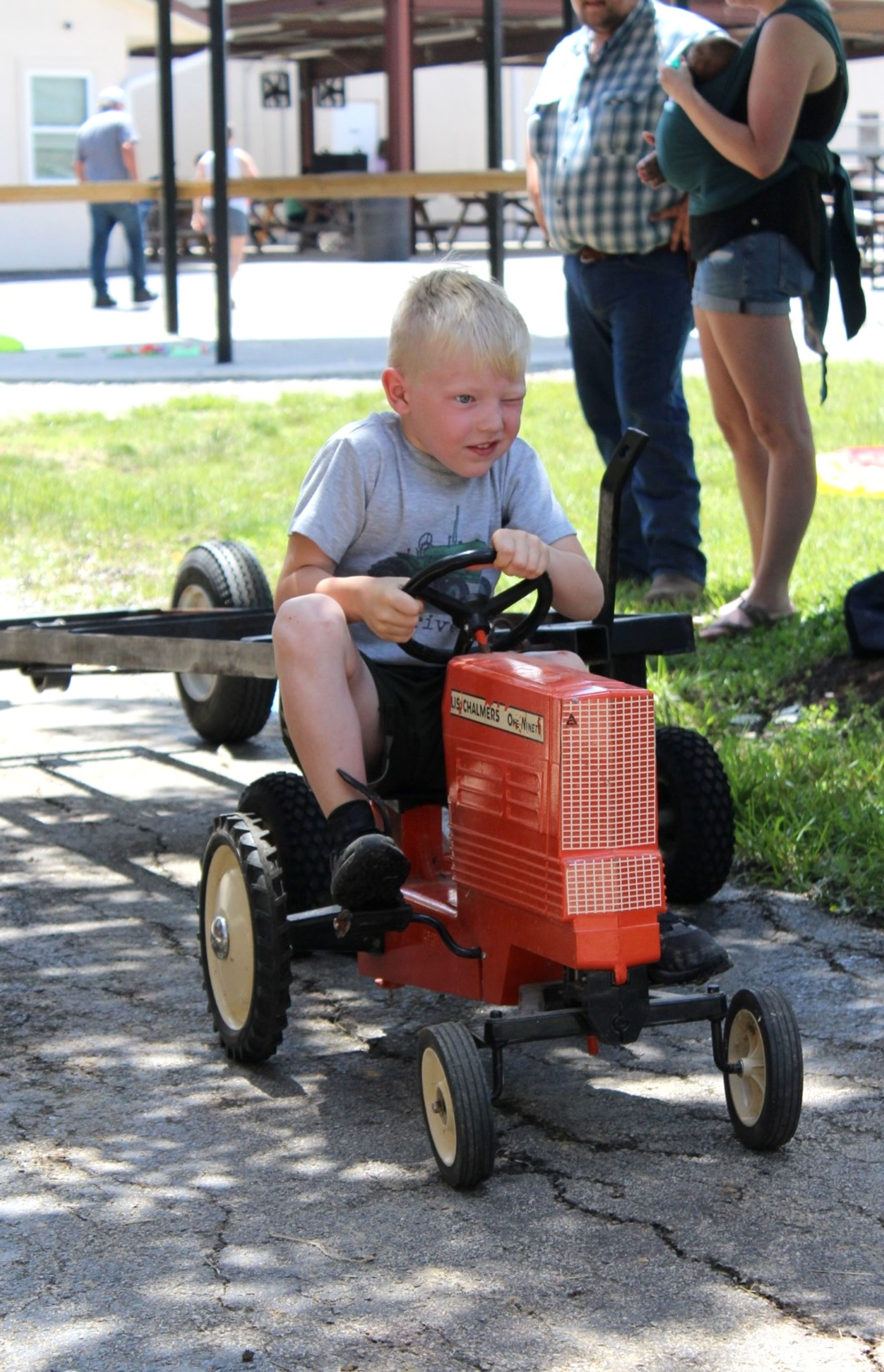 
Porter McClain pushes hard to compete in the pedal tractor pull.