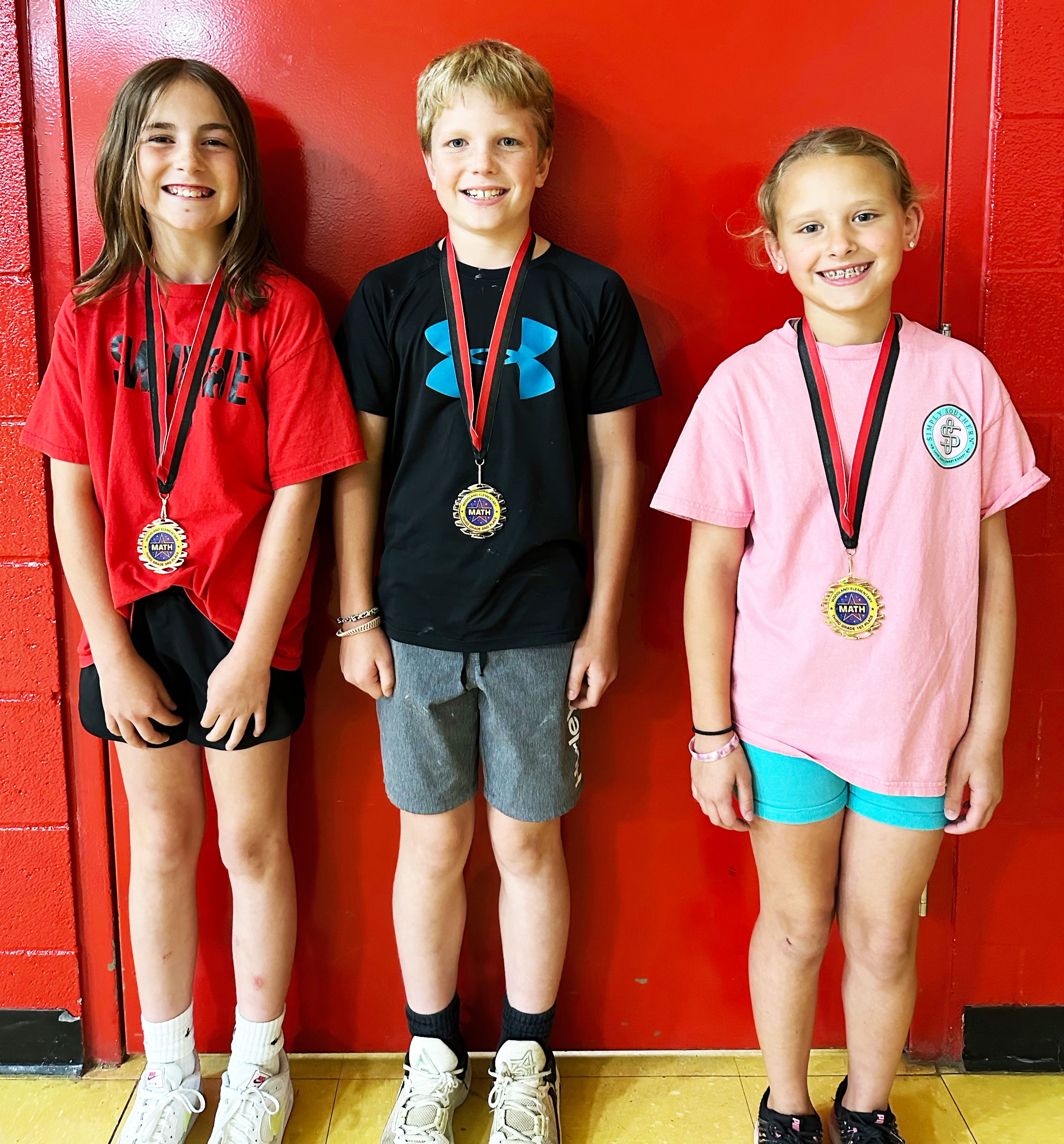 Third-grade winners (from left) include Hadlie Davault, third place; Clate VanGennip, second place; and Alaina Long, first place