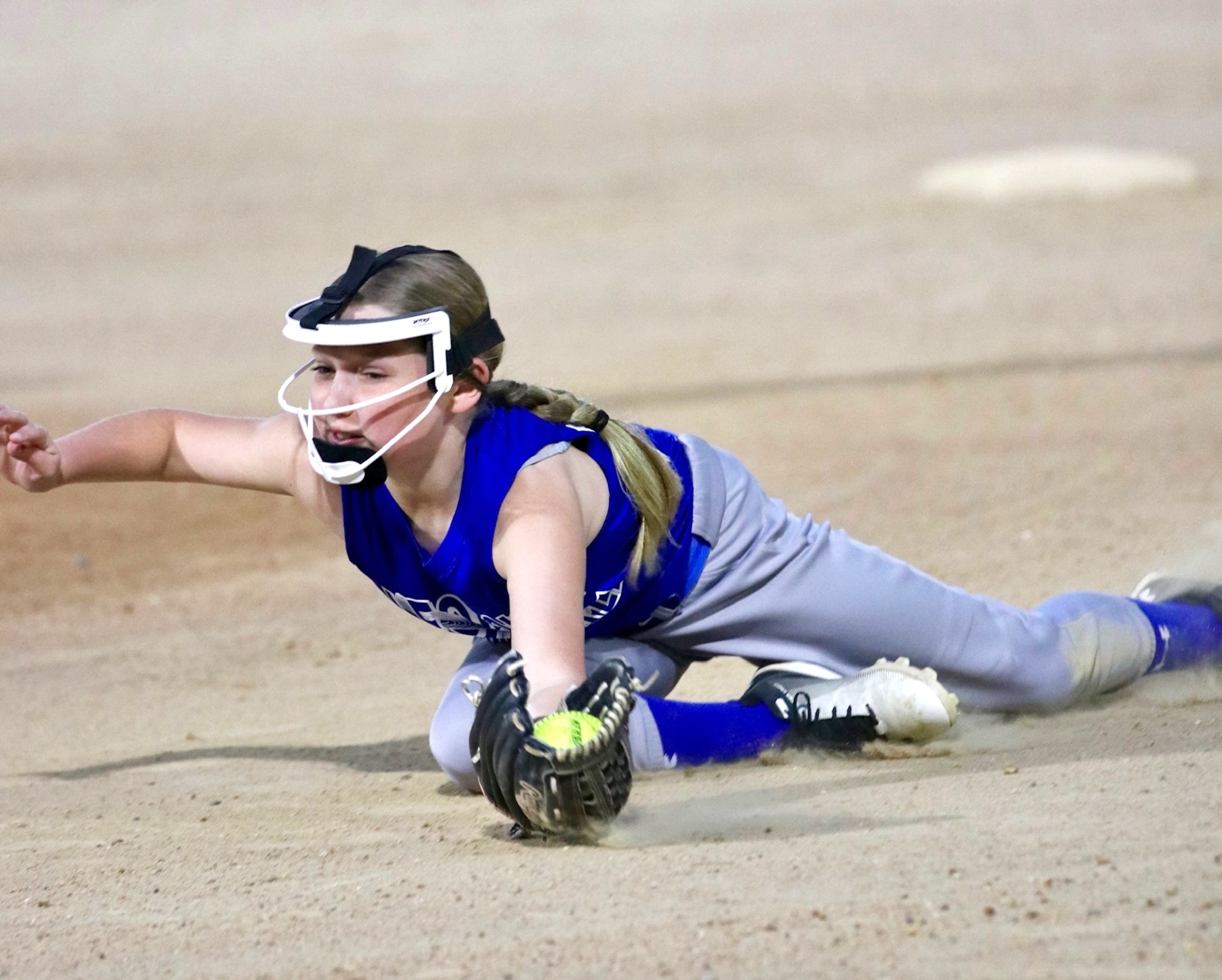 
Brooke Beussink completes a spectacular infield dive to catch a ball during the Friday night 12 Leopold softball game.