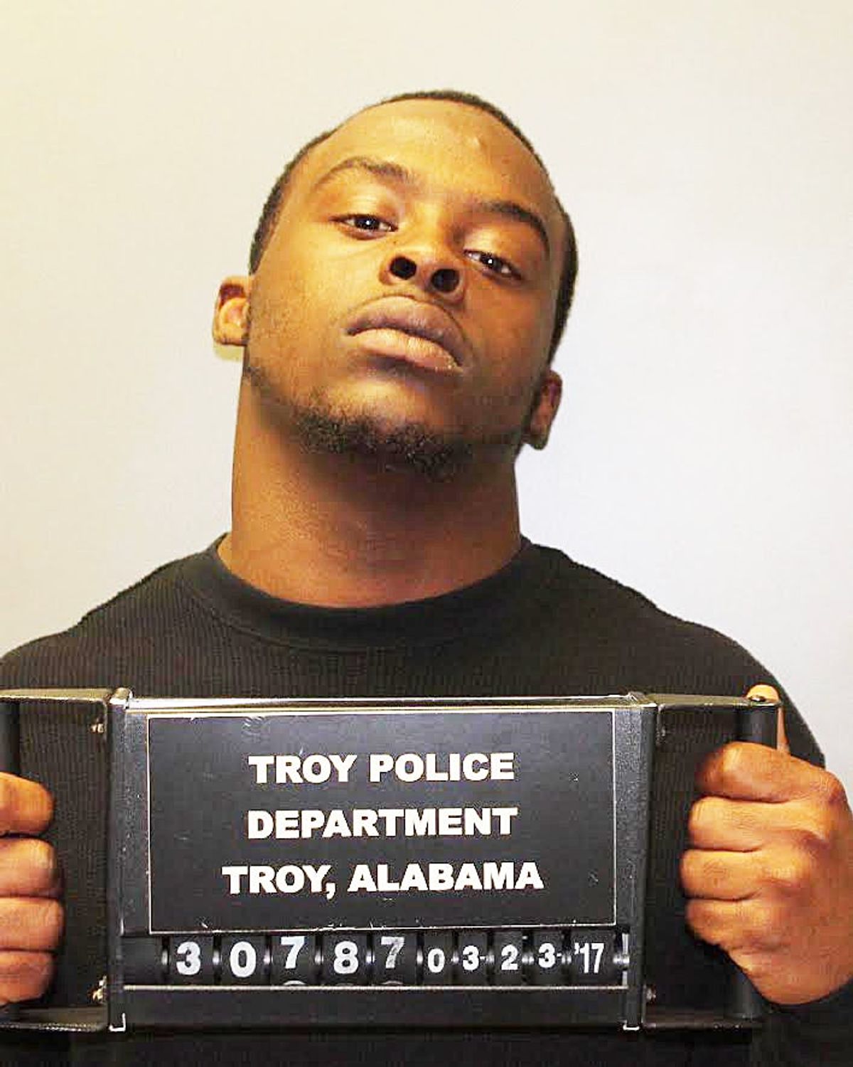Suspect charged with shooting into vehicle