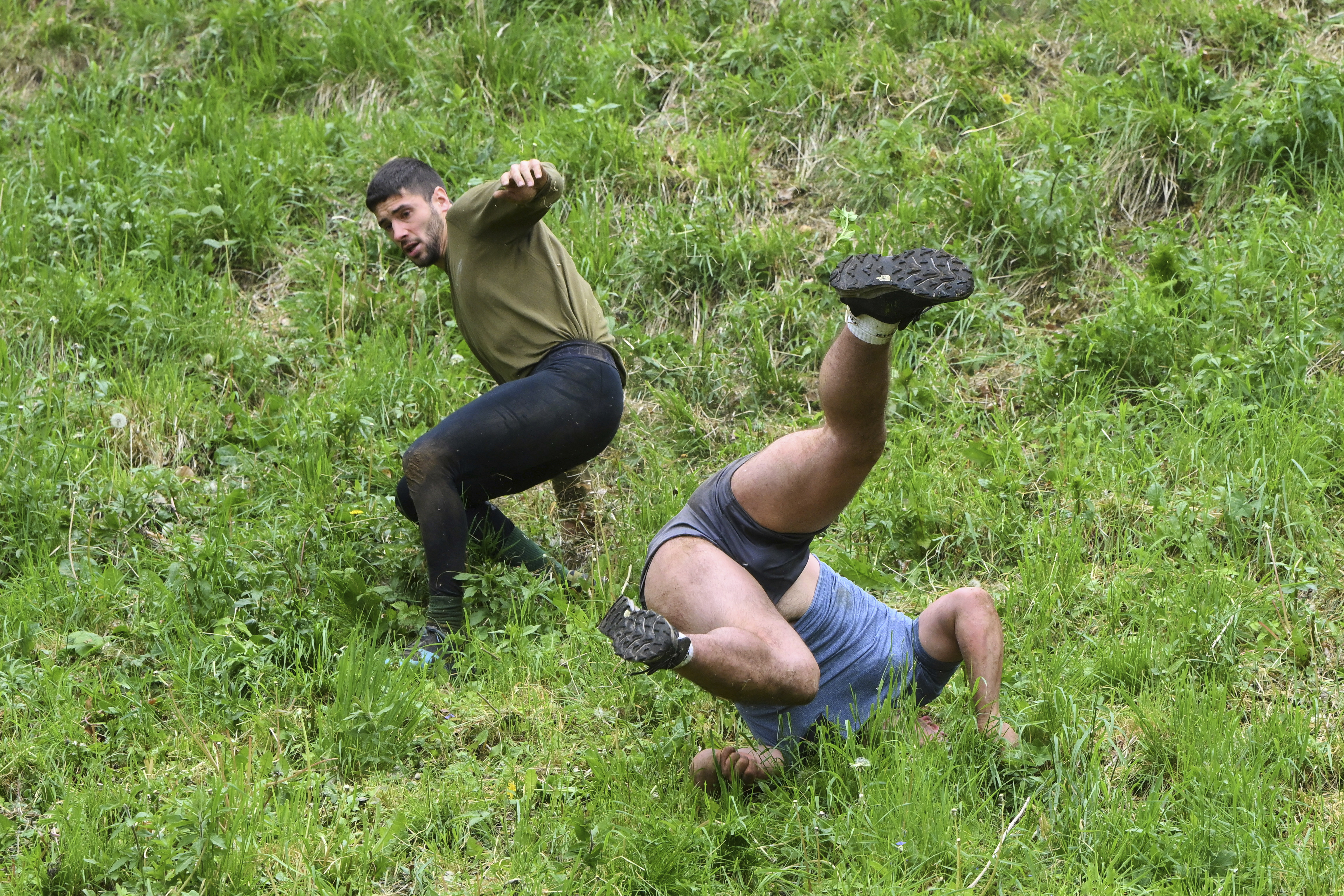 AP PHOTOS: Runners trip, stumble and roll their way to victo