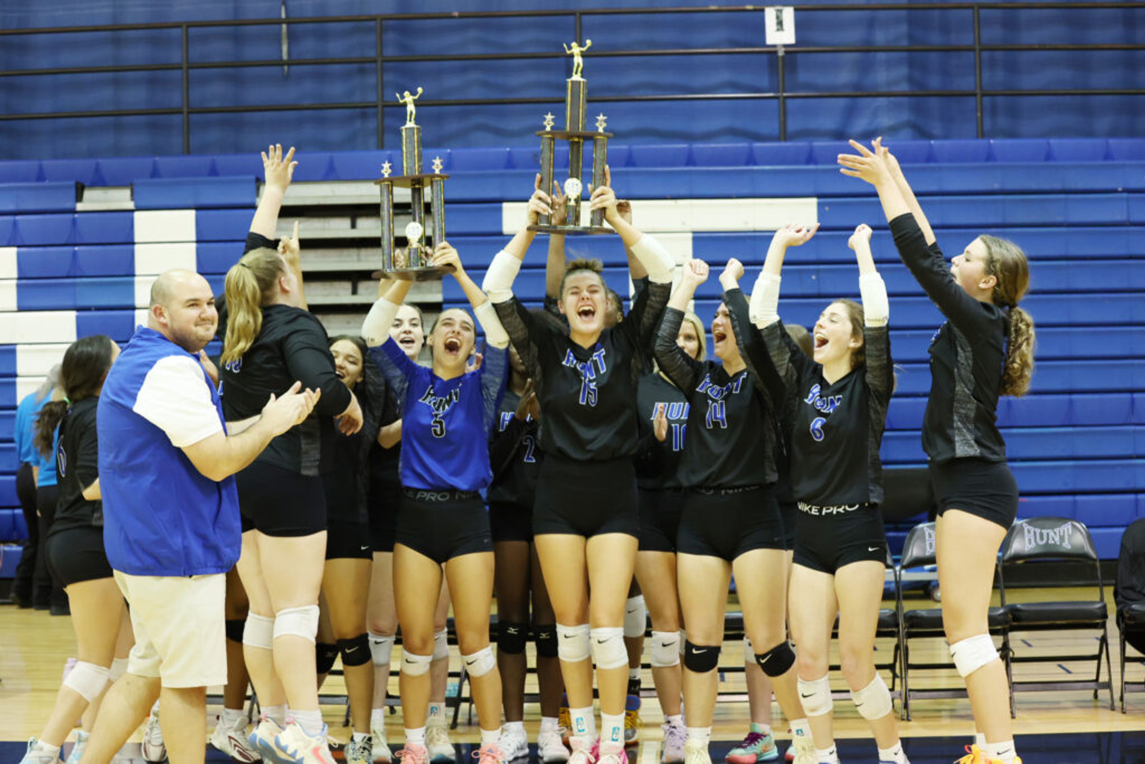 Hunt players and head coach Matt Lemmons, left, celebrate with their third straight regular-season and tournament championships in the 3-A Quad County Conference after defeating West Johnston in the tourney final Wednesday, Oct. 18, at Hunt. Sheldon Vick | Special to the Times
