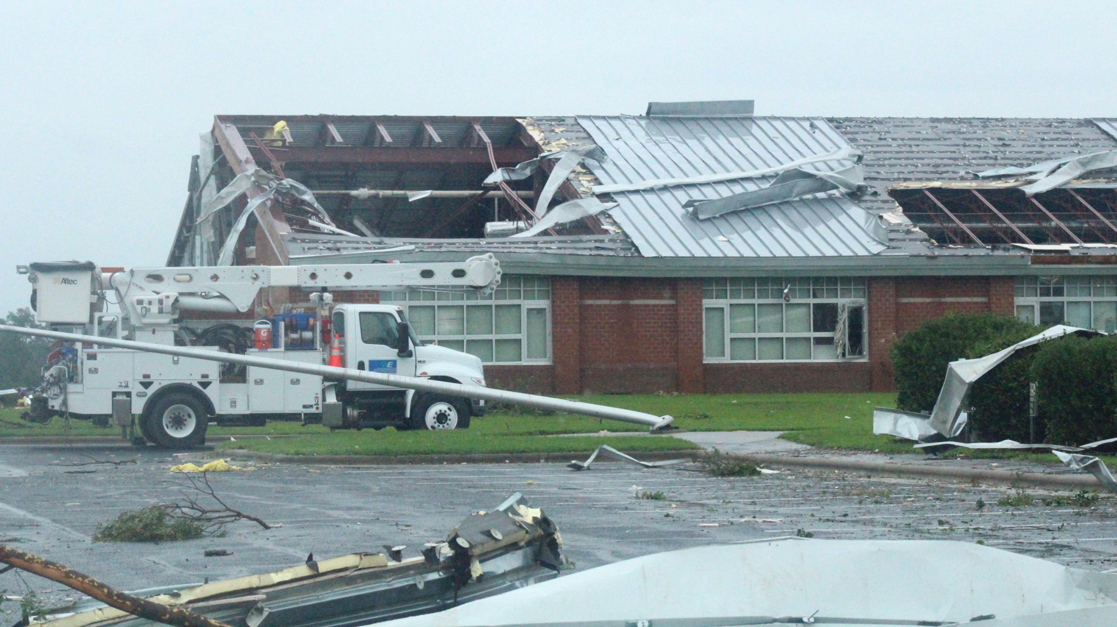 Debris is scattered around Springfield Middle School’s parking lot hours after a tornado caused significant damage to the building. Christopher Long | Times