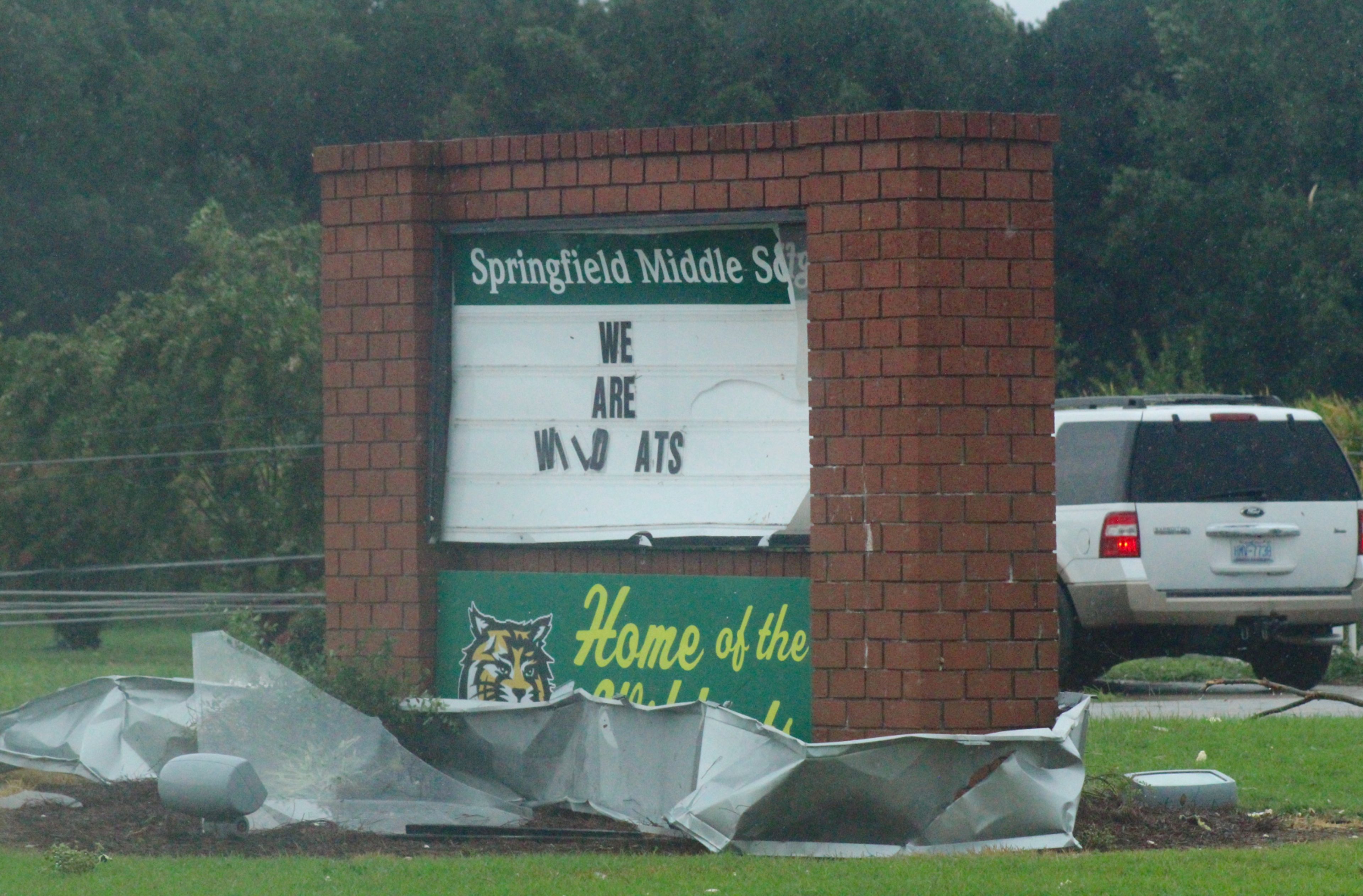 Springfield Middle School’s welcome sign is damaged after a tornado tore through the area early Thursday. A portion of the school’s roof is shown wrapped around the sign. Christopher Long | Times