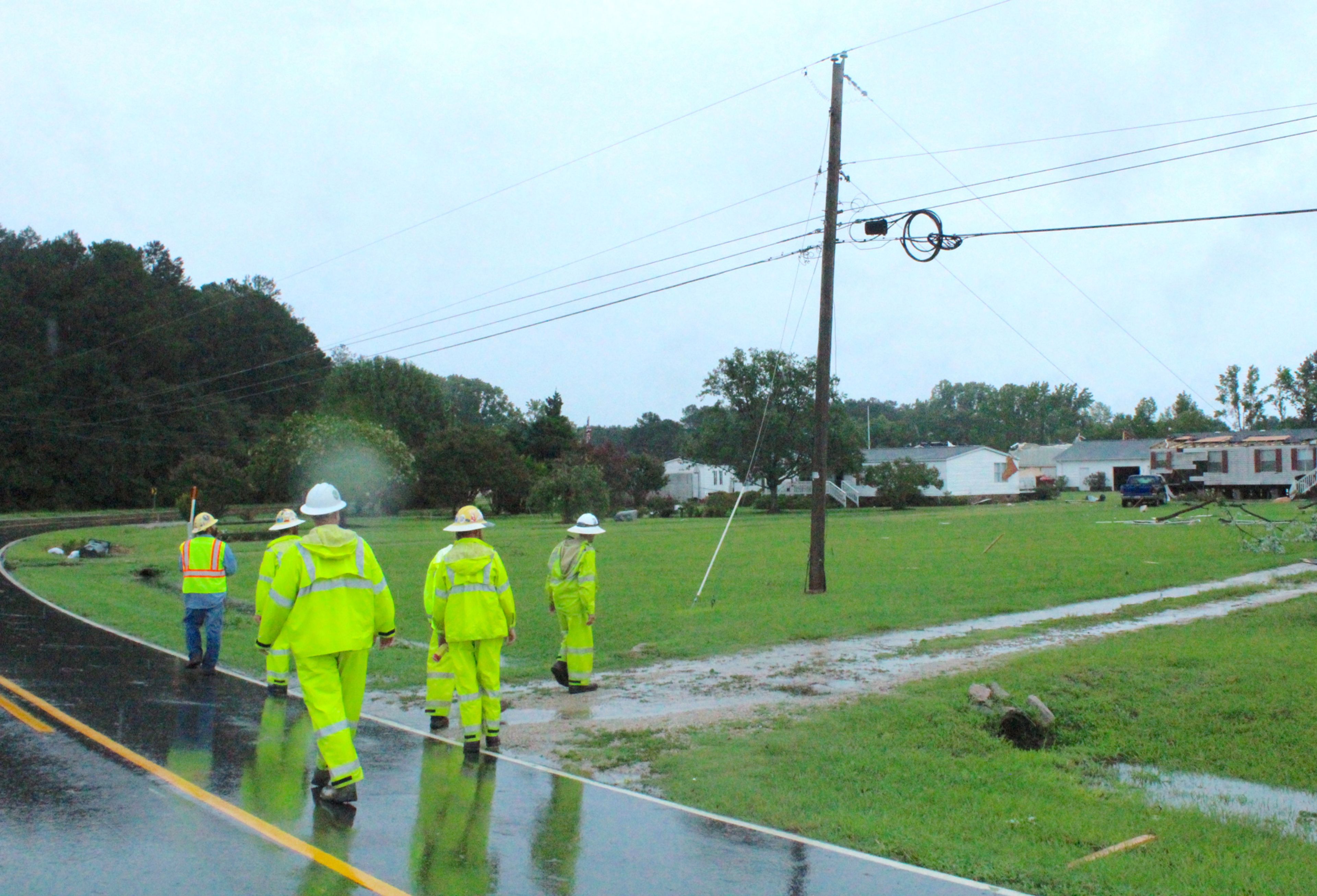 Wilson Energy workers assess storm damage on Lloyd Road outside Lucama while surveying what needs to be repaired. Christopher Long | Times