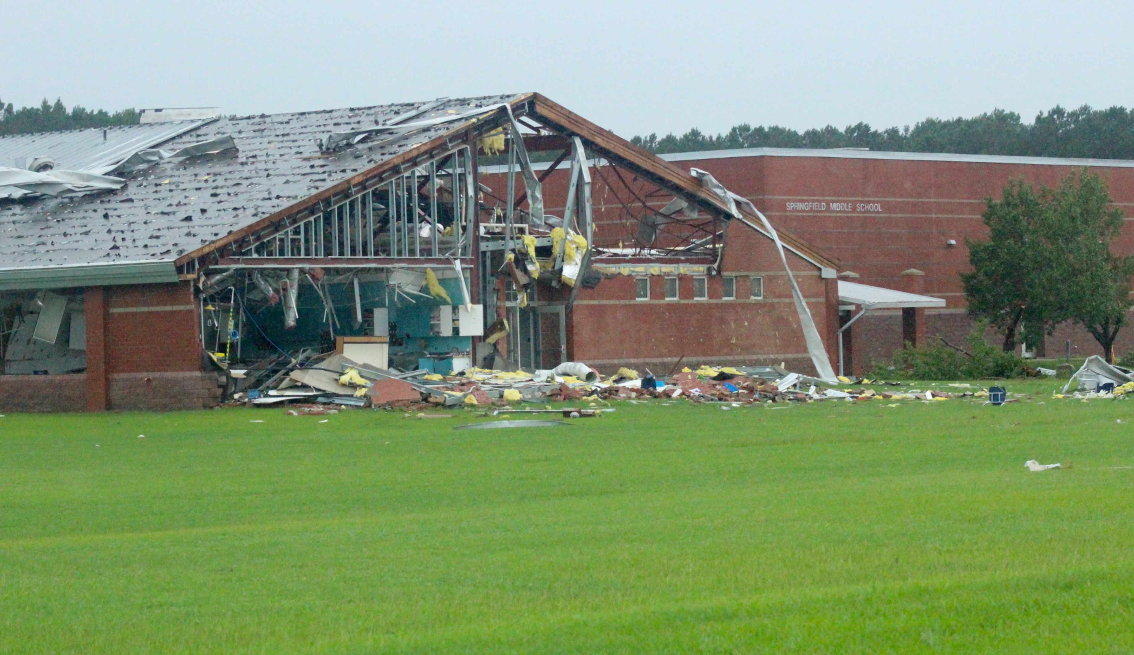 Emergency sirens rang out Thursday morning at Springfield Middle School hours after a tornado ripped off the roof and destroyed much of the school’s left wing. Christopher Long | Times