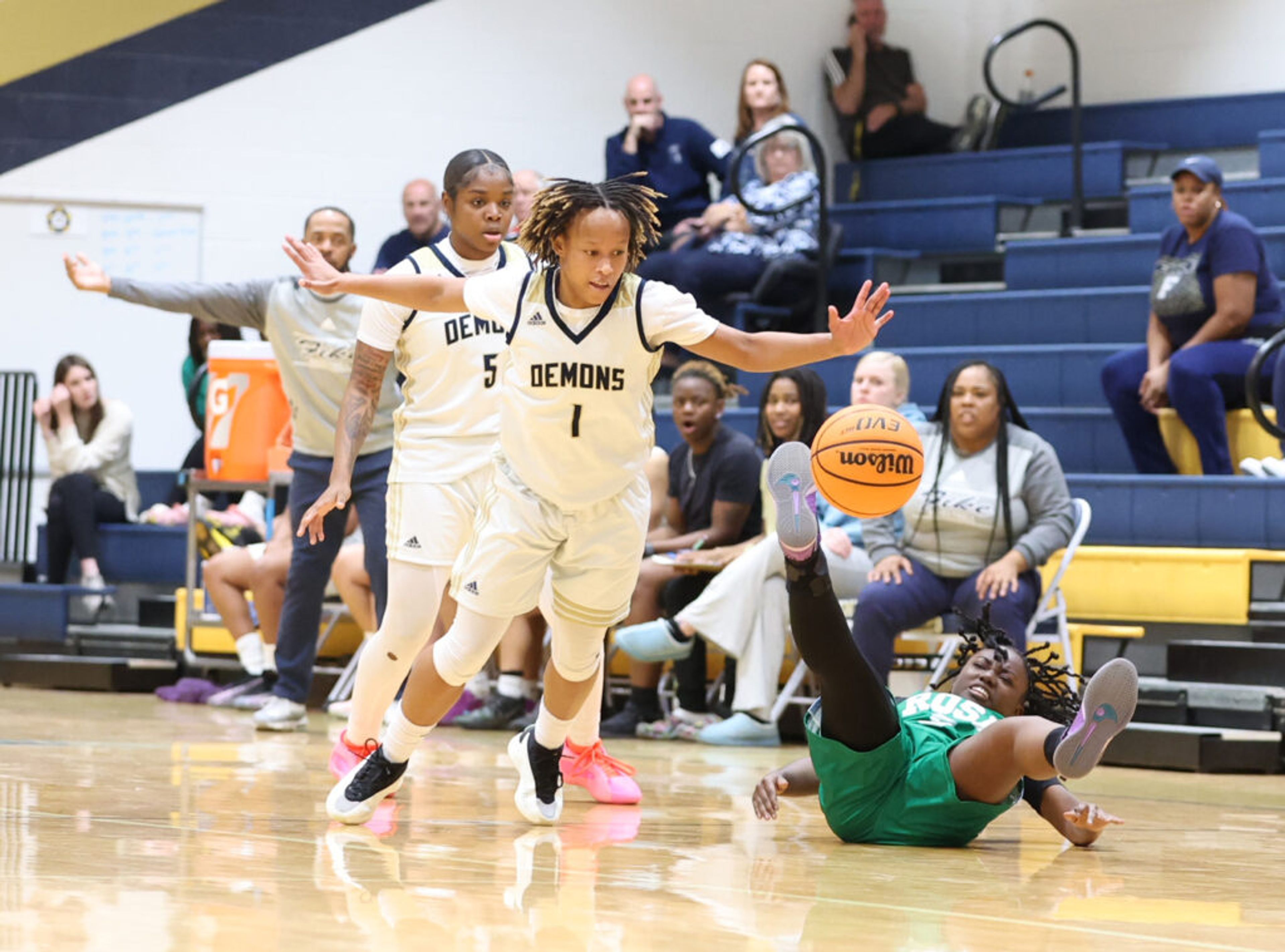 Fike's Jewel Brewington (1) comes up with a steal of the ball from a prone J.H. Rose player while Golden Demons teammate Jamaria Freeman (5) looks on during an NCHSAA 3-A first-playoff game Tuesday, Feb. 25, at Fike. Sheldon Vick | Special to the Times