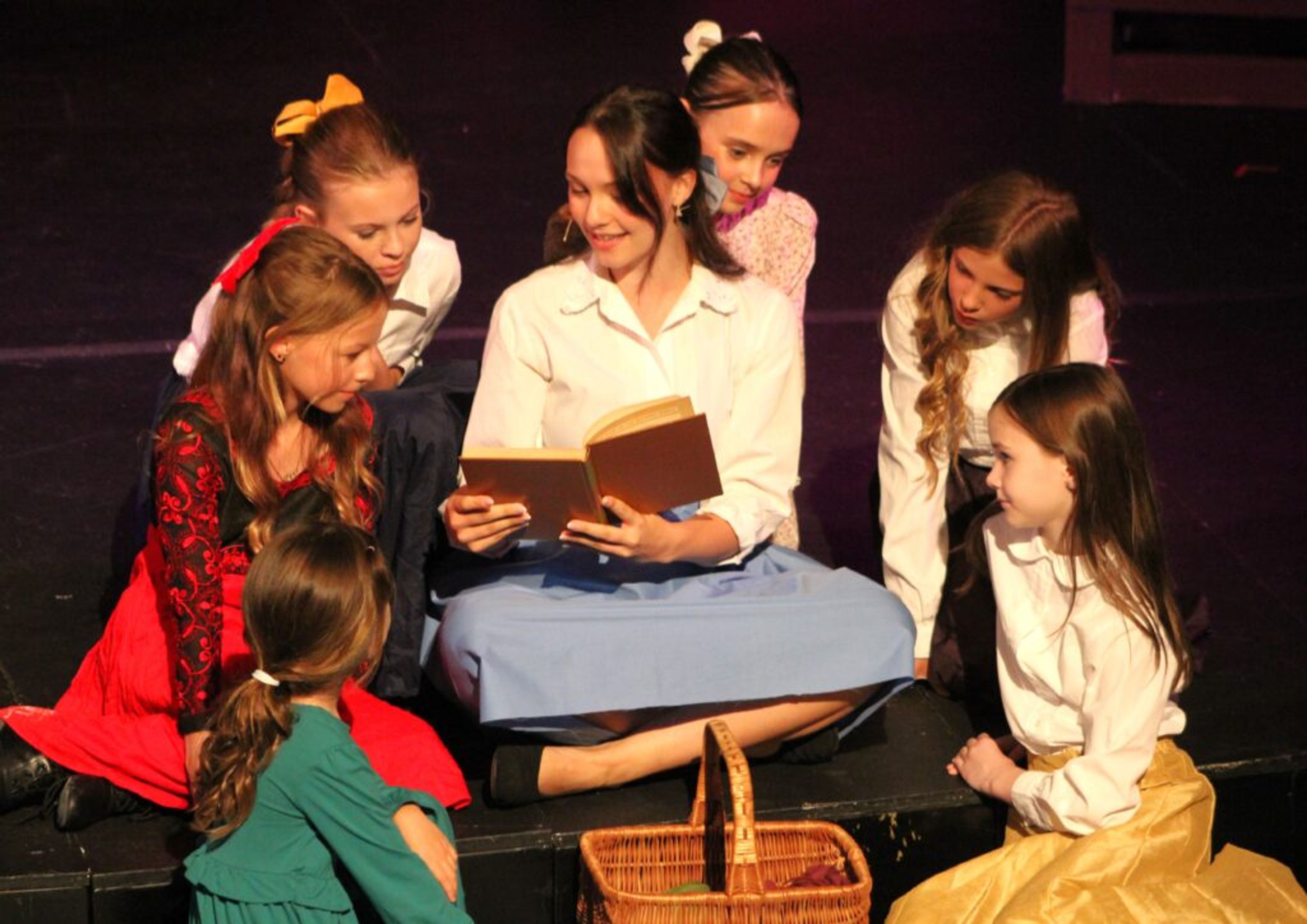 Breanna Smith, as Belle, reads to curious children in the 2024 Wilson Summer Community Musical “Beauty and the Beast,” playing Thursday through Sunday at the Boykin Center. Cast members surrounding Smith, starting at bottom left, are Annalise Gonzalez, Giselle Owens, Lily Carlton, Alma Stancil, Emma Powell and Imogen Edwards. Janelle Clevinger | Special to the Times