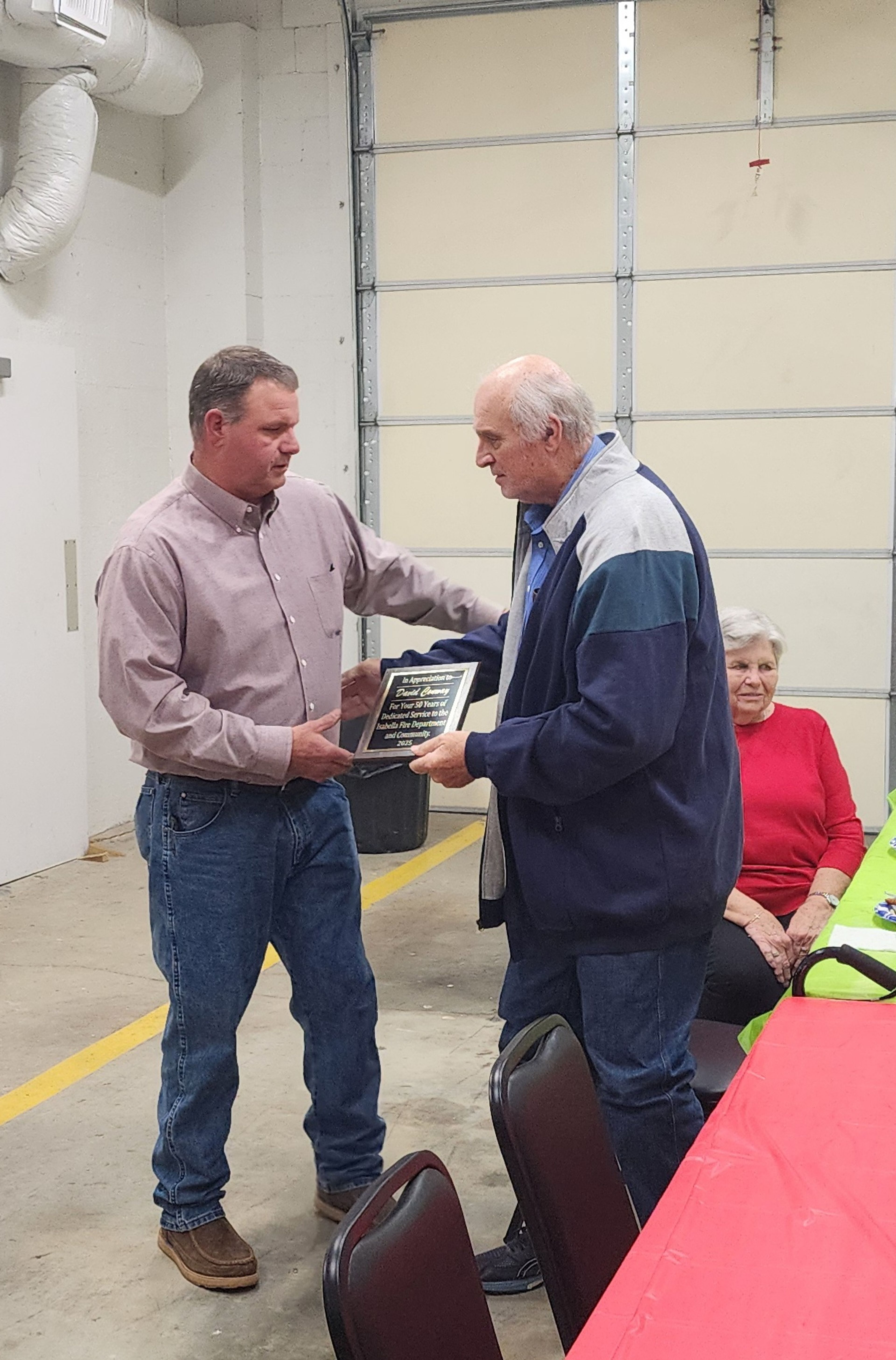  David Conway receiving his plaque honoring him for his dedication to the Isabella Volunteer Fire Department.  