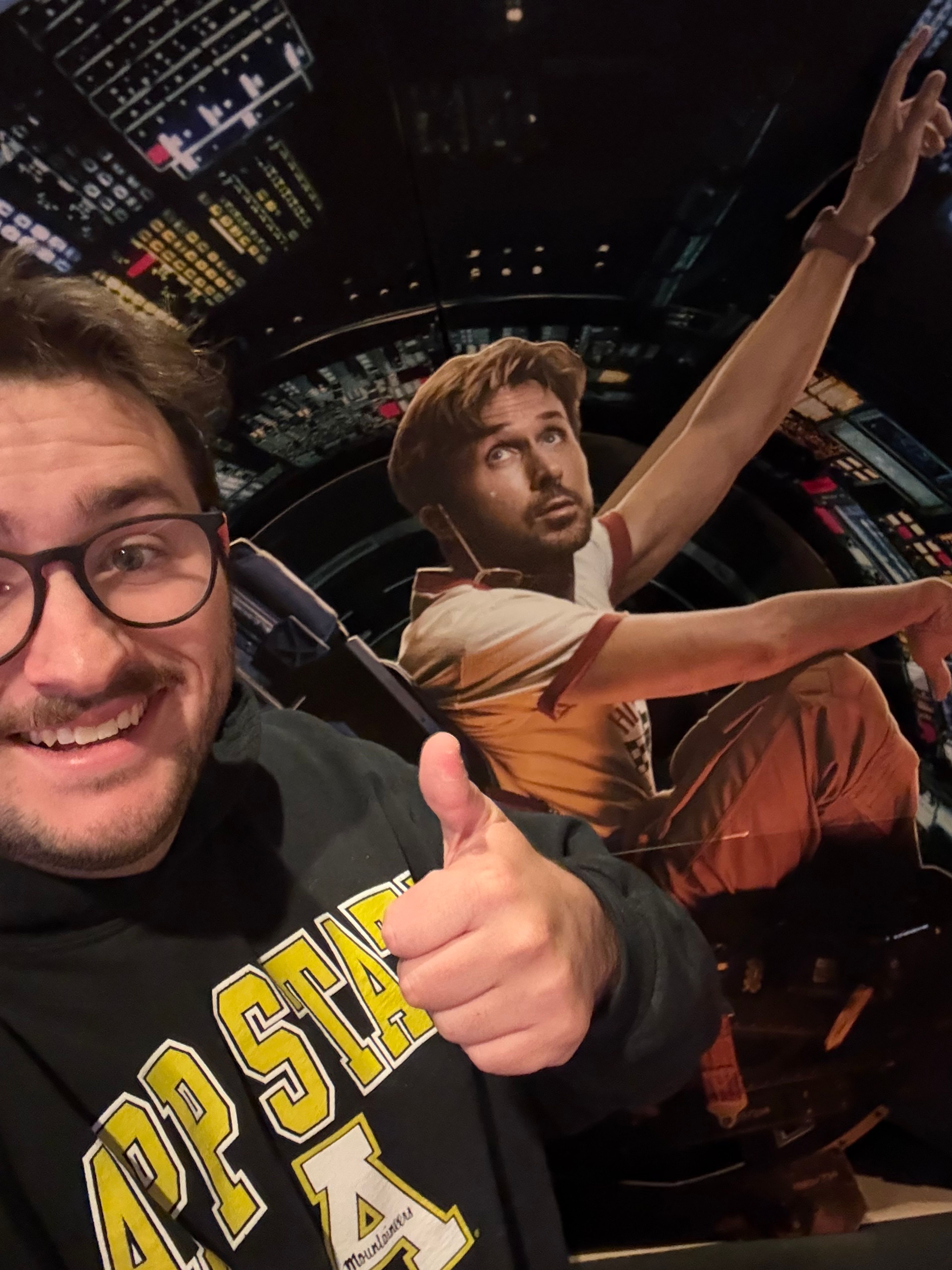 A photo of me and a cardboard cutout of Ryland Grace from the movie. 