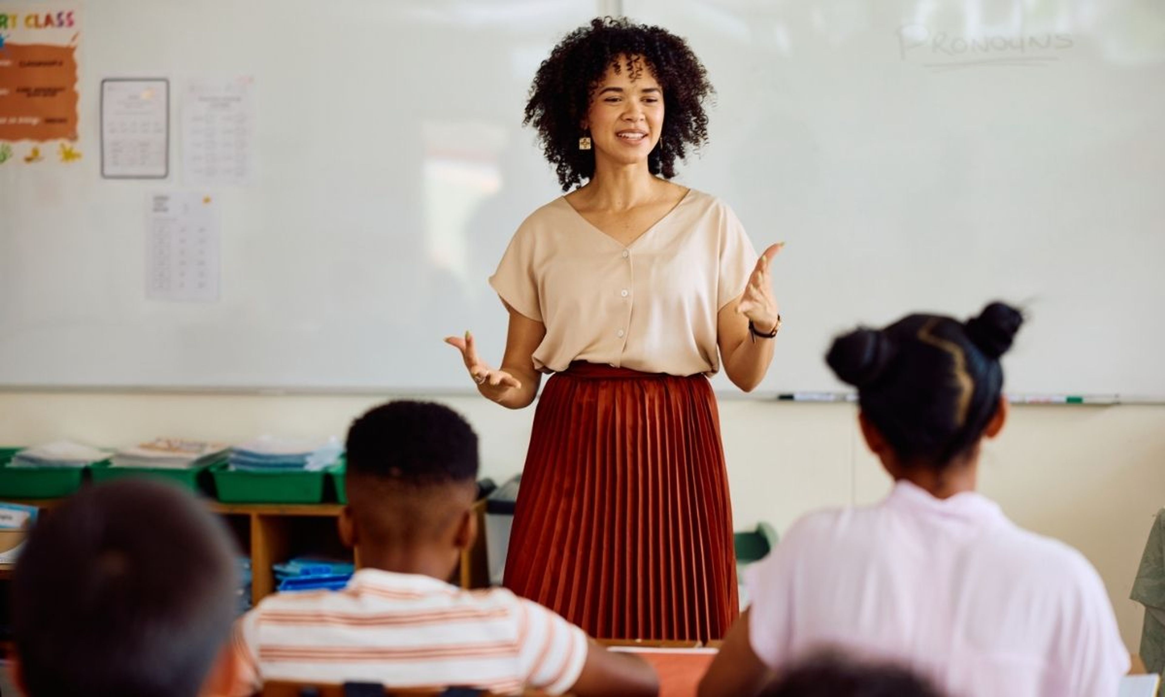 Teacher speaks to students in a classroom as U-46 School Board approves 2026 budget to expand staffing and modernize schools.