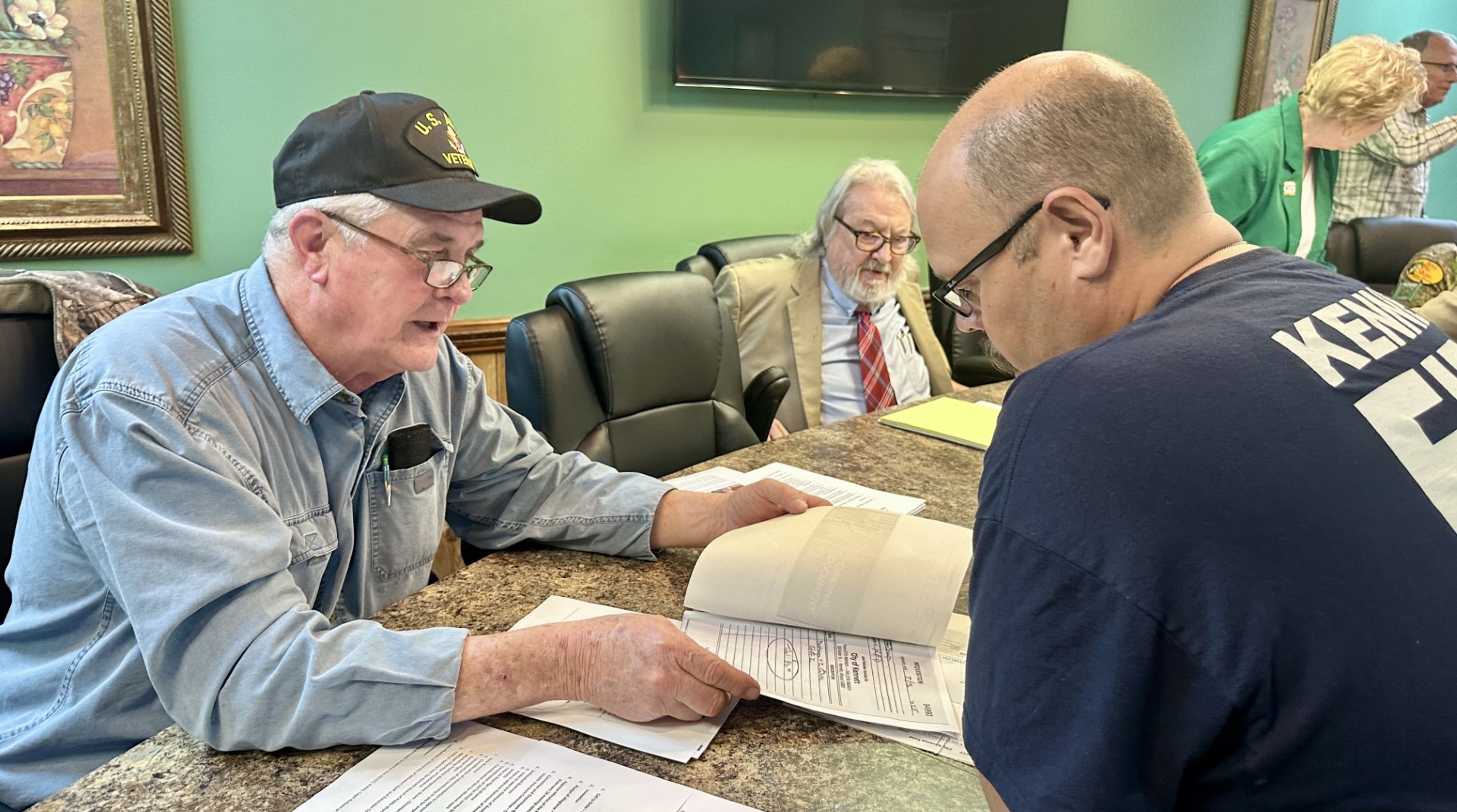 Ward II Kennett City Councilor James Waynick, left, reviews documents with Kennett Fire Dept. Chief Lance Davis at Tuesday's meeting of the Kennett City Council.