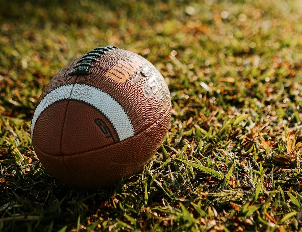 Leake Academy football team executing a rushing play during the game