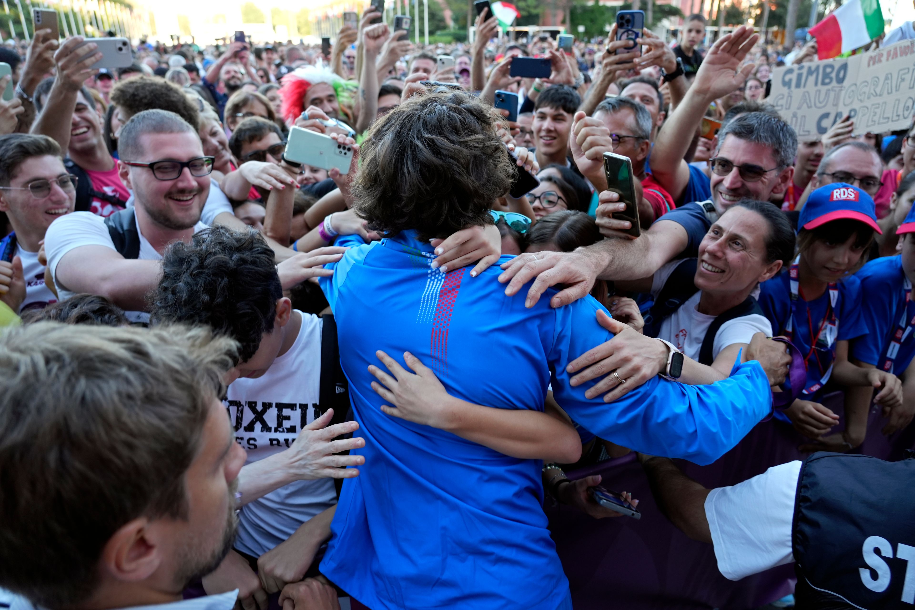 The men's high jump gold medalist Gianmarco Tamberi, of Italy, is greeted by fans at the European Athletics Championships in Rome, Wednesday, June 12, 2024. (AP Photo/Stefano Costantino)