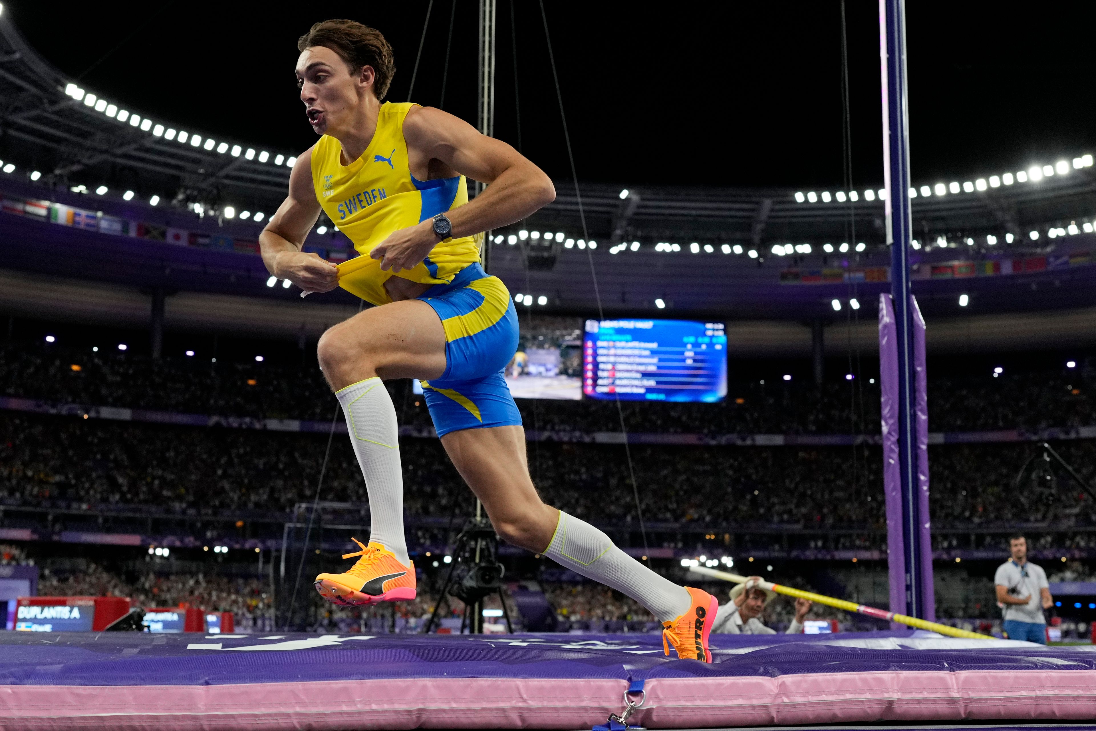 Armand Duplantis, of Sweden, celebrates after setting a new world record in the men's pole vault final at the 2024 Summer Olympics, Monday, Aug. 5, 2024, in Saint-Denis, France. (AP Photo/Bernat Armangue)