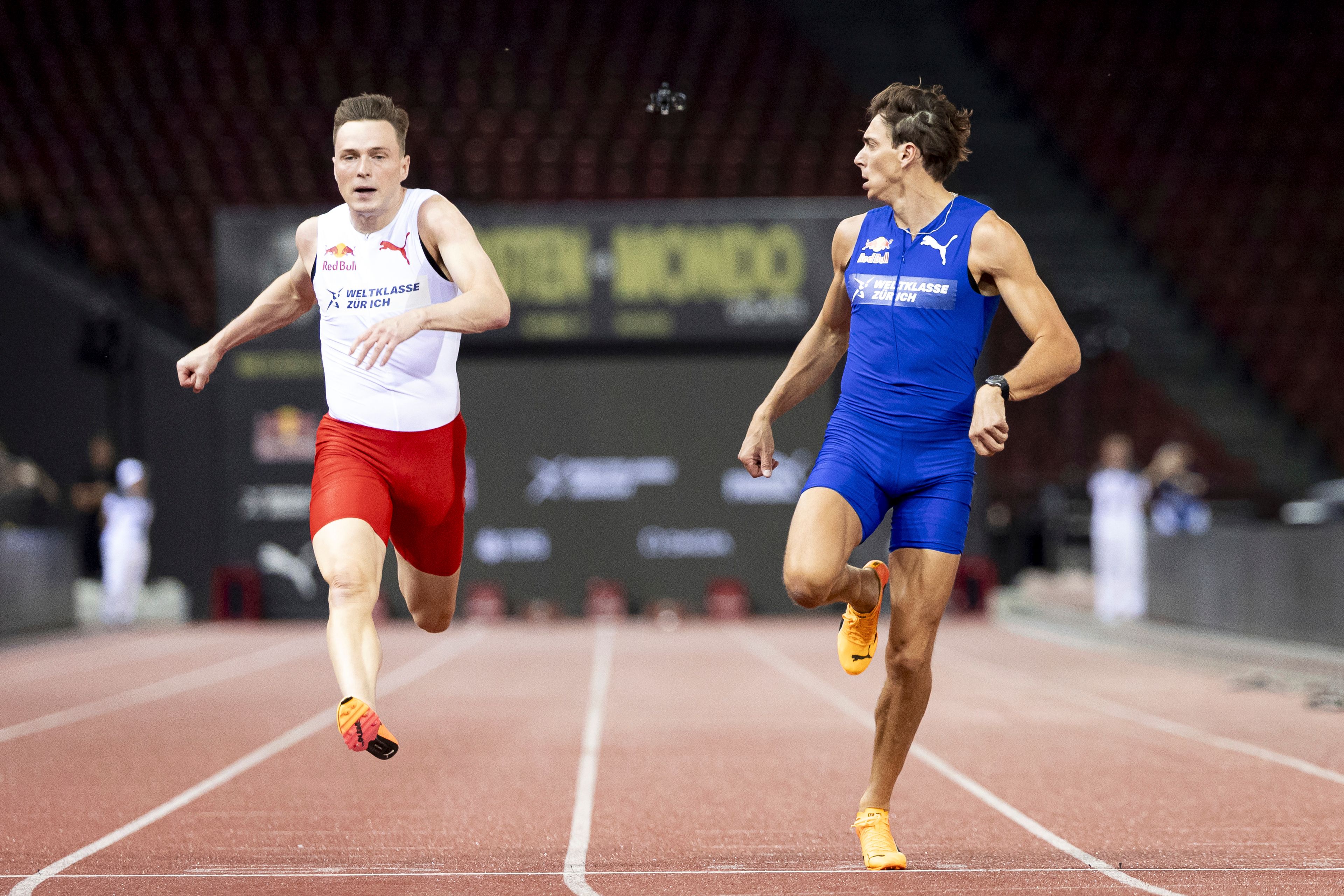 Armand Duplantis, right, of Sweden, crosses the finish line front of Karsten Warholm, of Norway, during a 100 meters sprint at the IAAF Diamond League Athletics meet, Wednesday, Sept. 4, 2024 in Zurich, Switzerland. (Michael Buholzer/Keystone via AP)