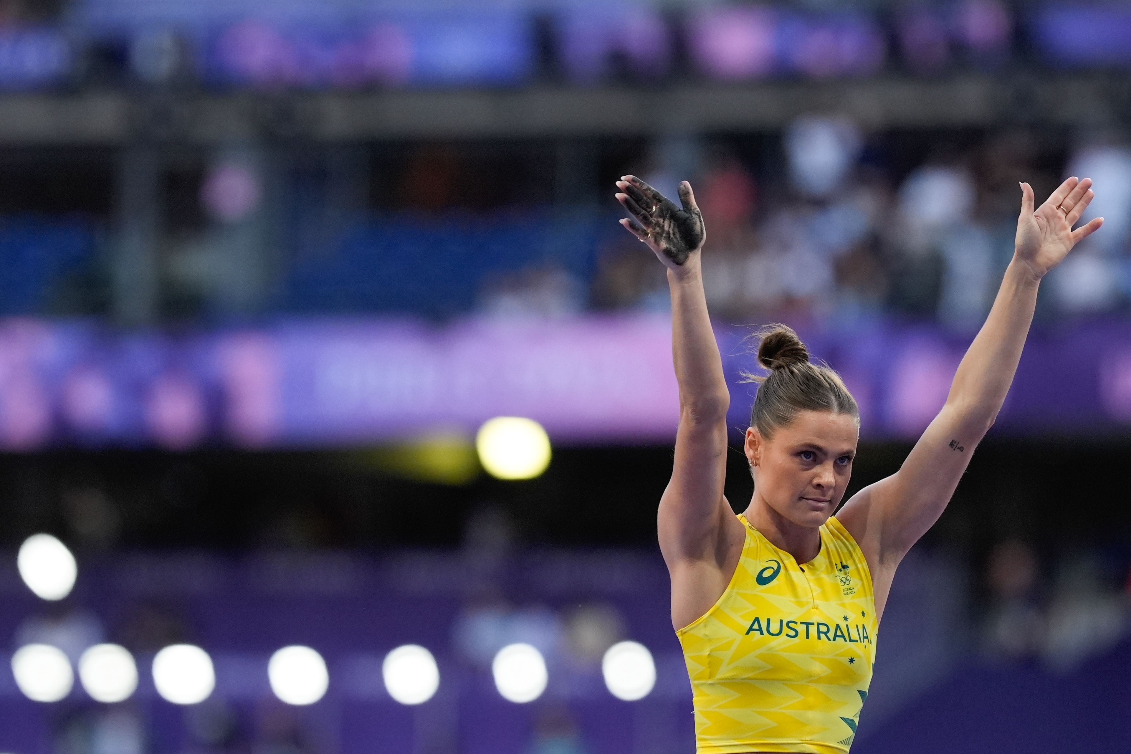 Nina Kennedy, of Australia, raises her arms after a successful vault, in the women's pole vault final at the 2024 Summer Olympics, Wednesday, Aug. 7, 2024, in Saint-Denis, France. (AP Photo/Rebecca Blackwell)