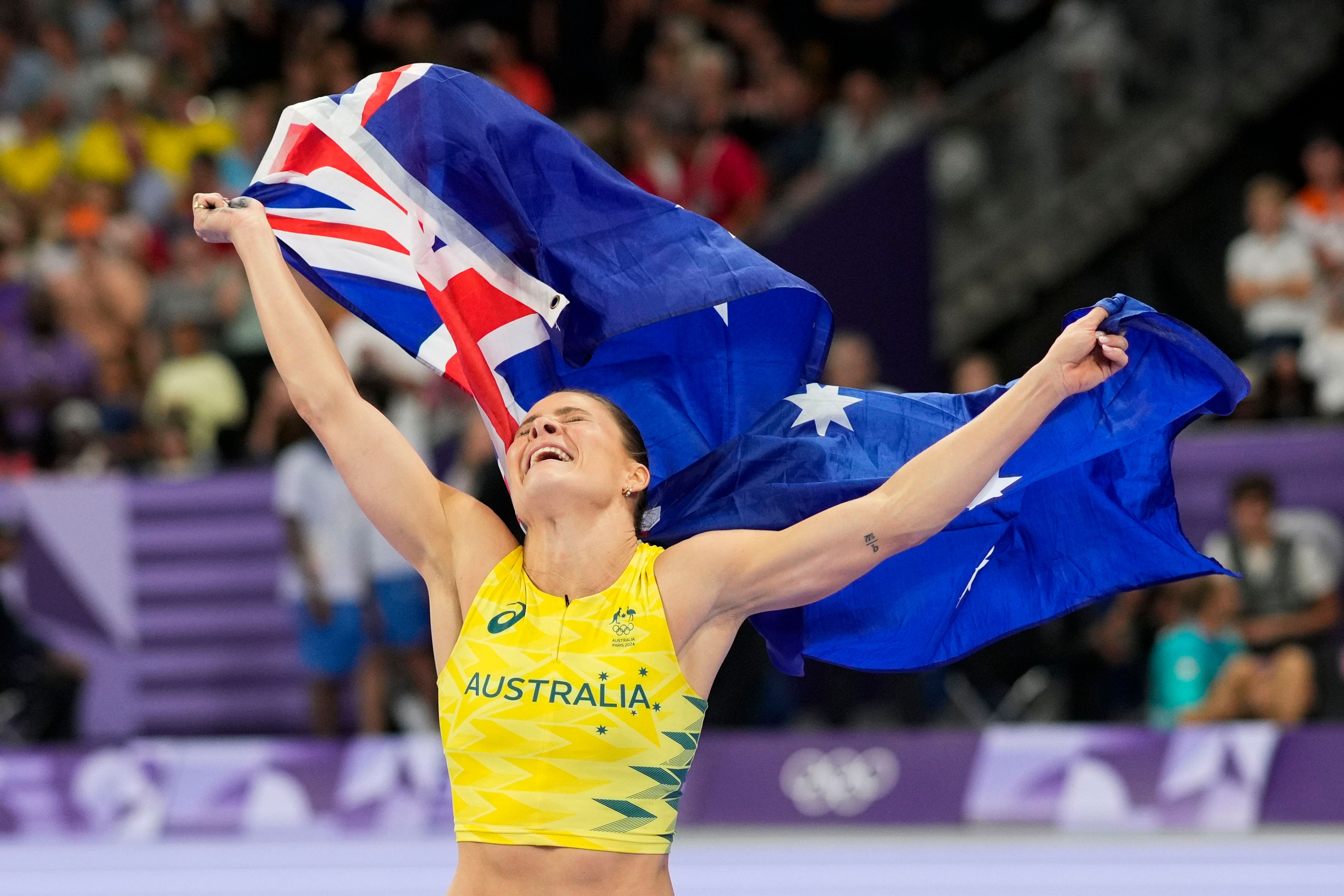 Nina Kennedy, of Australia, celebrates after winning the women's pole vault final at the 2024 Summer Olympics, Wednesday, Aug. 7, 2024, in Saint-Denis, France. (AP Photo/Bernat Armangue)