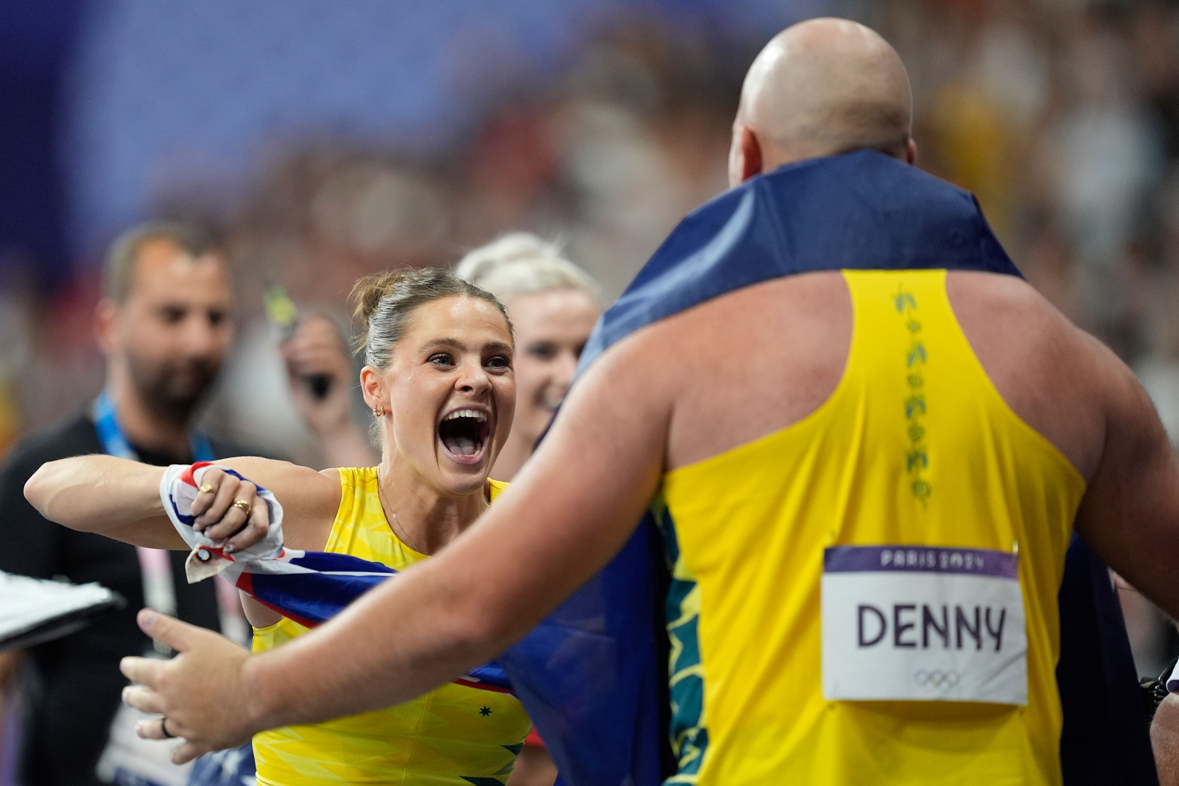 Nina Kennedy, of Australia, celebrates after winning gold in the women's pole vault final, along with Matthew Denny, of Australia, who won bronze in the men's discus throw final, at the 2024 Summer Olympics, Wednesday, Aug. 7, 2024, in Saint-Denis, France. (AP Photo/Rebecca Blackwell)