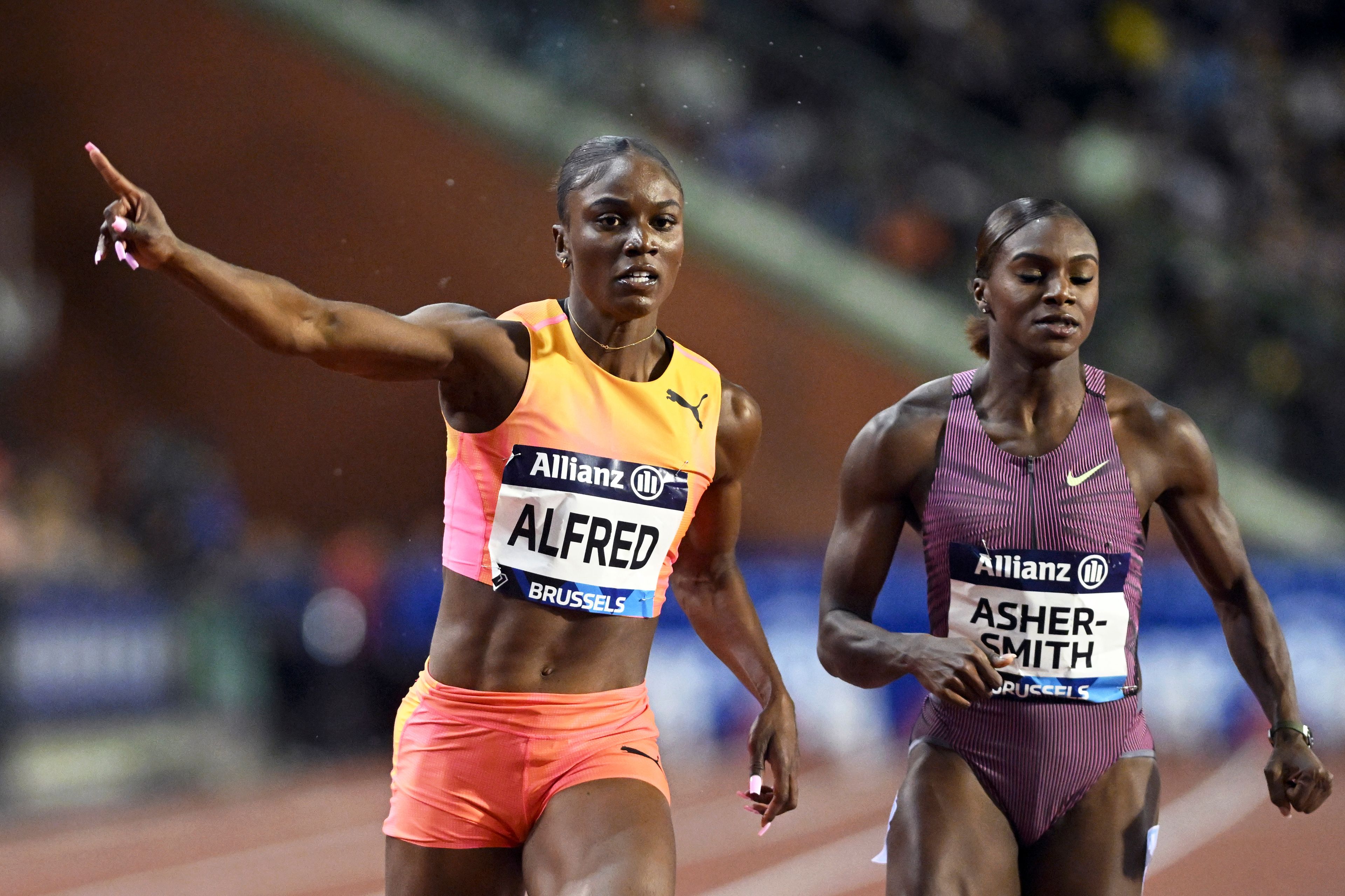 Julien Alfred, of Saint Lucia, crosses the finish line to win the women's 100 meters during the Diamond League final 2024 athletics meet in Brussels, Friday, Sept. 13, 2024. At right is second placed Dina Asher-Smith, of Great Britain. (AP Photo/Frederic Sierakowski)