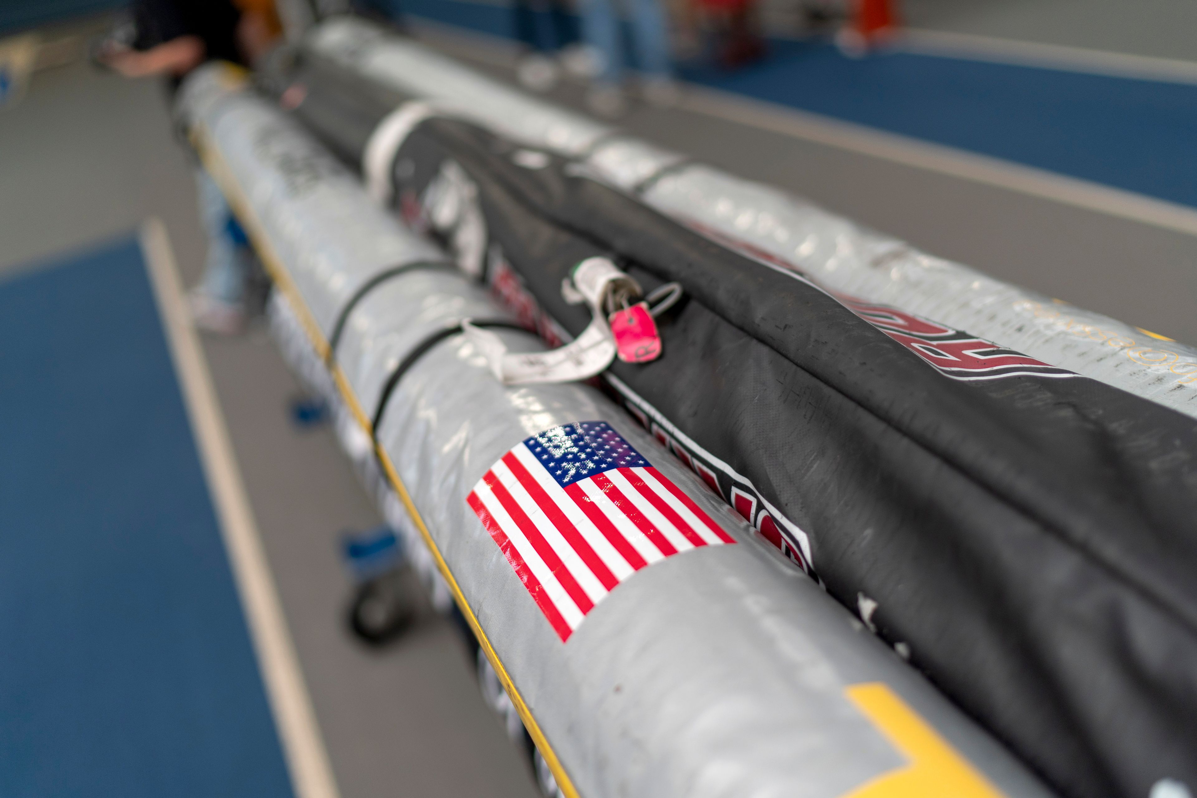 An American flag and luggage tags decorate pole vault bags on the track at the Team USA training facility at the 2024 Summer Olympics, Tuesday, July 30, 2024, in Eaubonne, France. (AP Photo/David Goldman)