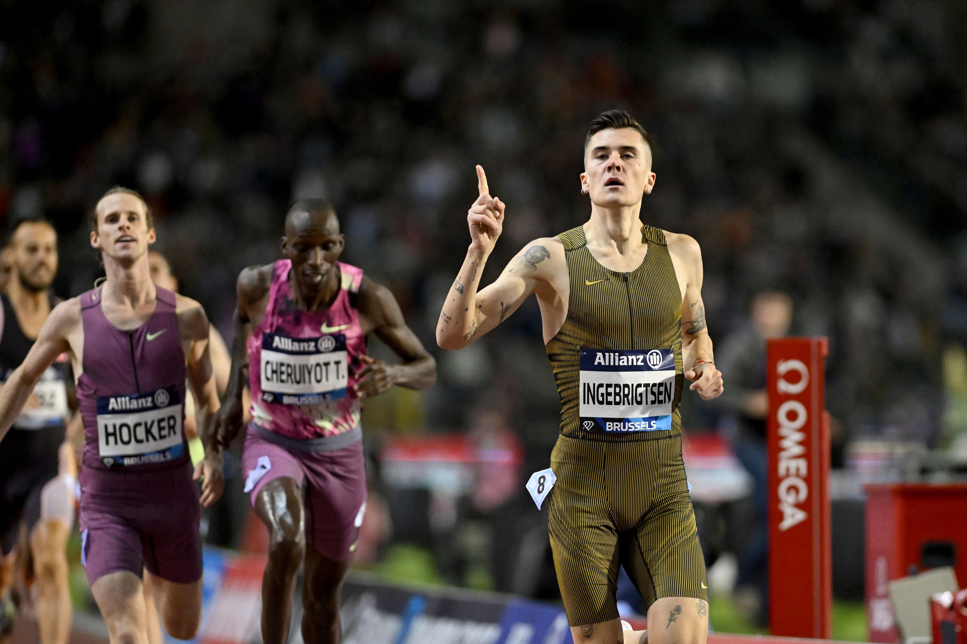 Jakob Ingebrigtsen, of Norway, crosses the finish line to win the men's 1500 meters ahead of Timothy Cheruiyot, of Kenya, during the Diamond League final 2024 athletics meet in Brussels, Friday, Sept. 13, 2024. (AP Photo/Frederic Sierakowski)