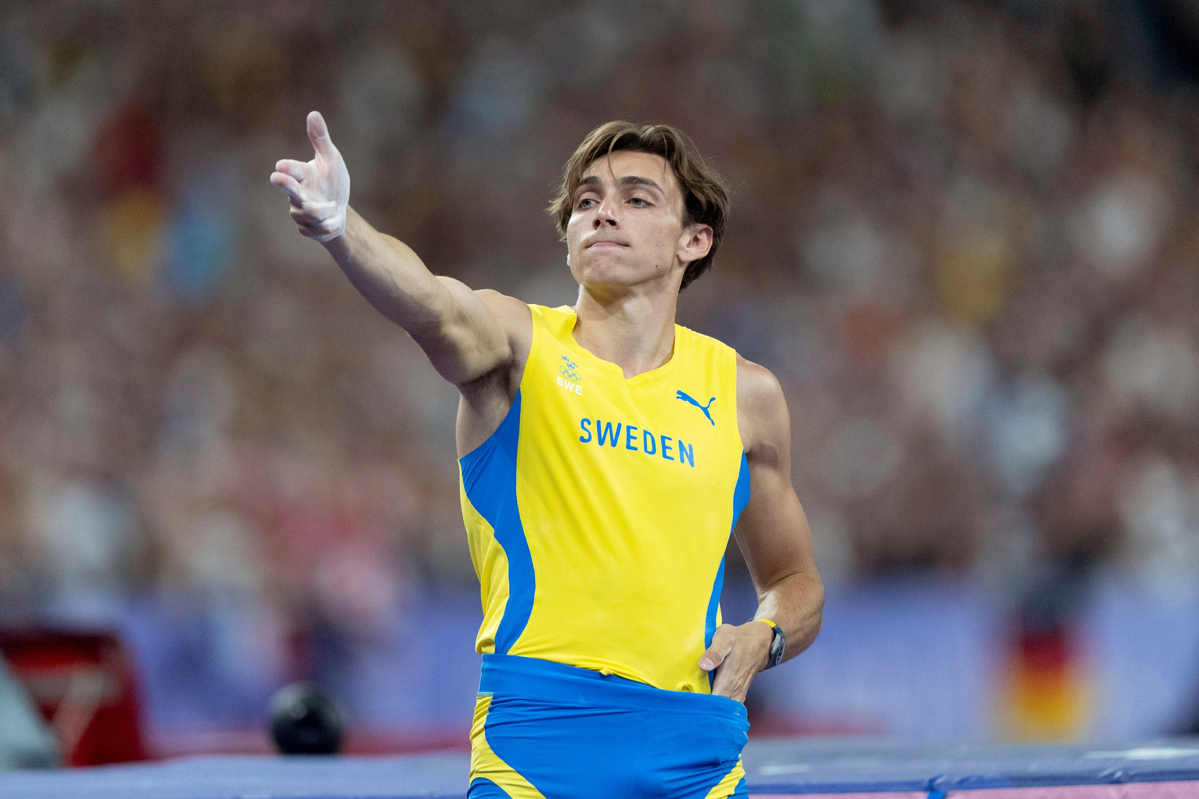 Armand Duplantis, of Sweden, reacts after setting a new Olympic record in the men's pole vault final at the 2024 Summer Olympics, Monday, Aug. 5, 2024, in Saint-Denis, France. (AP Photo/David Goldman)