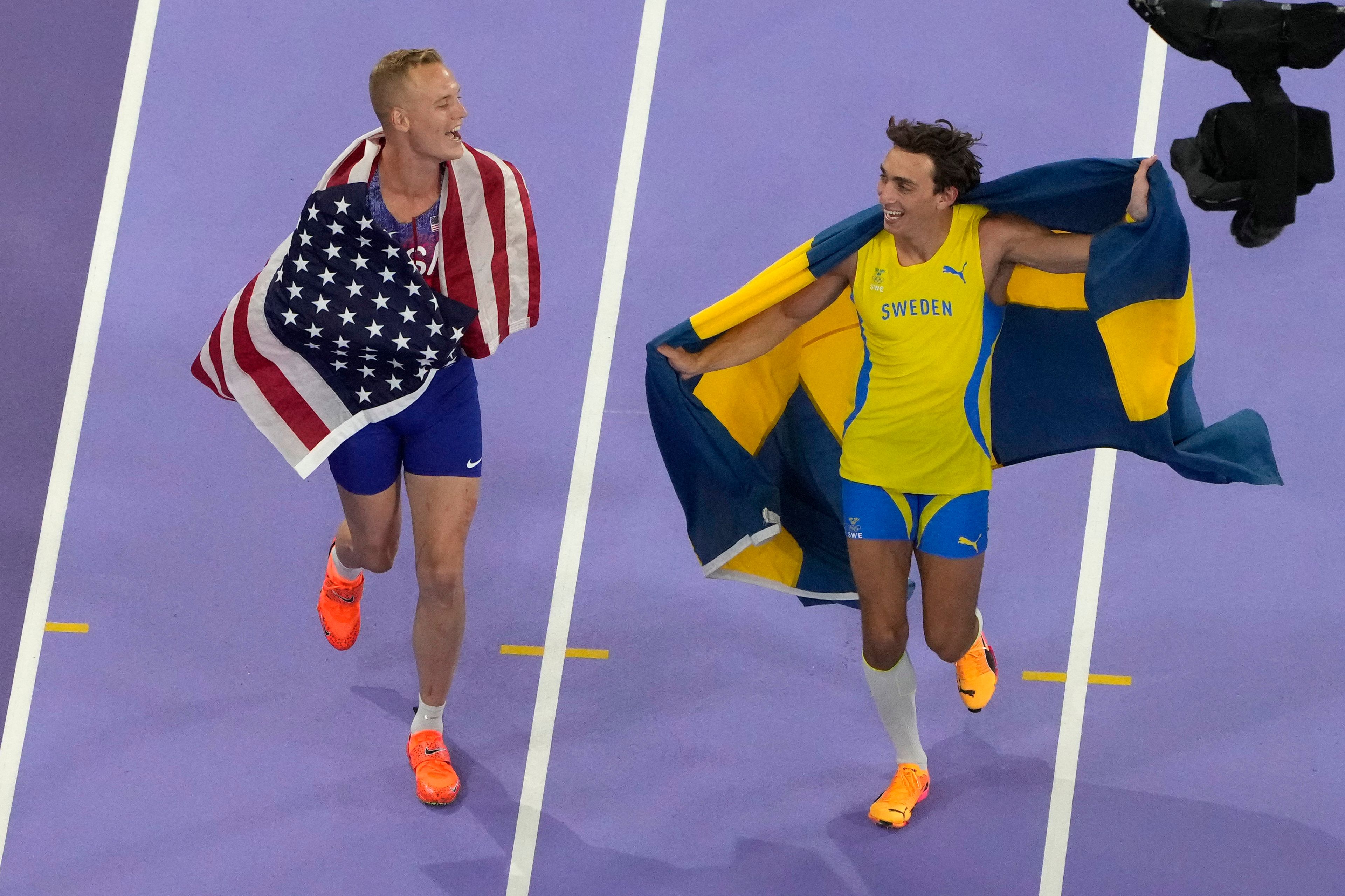 Sam Kendricks, of the United States, left, and Armand Duplantis, of Sweden, celebrate after the men's pole vault final at the 2024 Summer Olympics, Monday, Aug. 5, 2024, in Saint-Denis, France. (AP Photo/David J. Phillip)