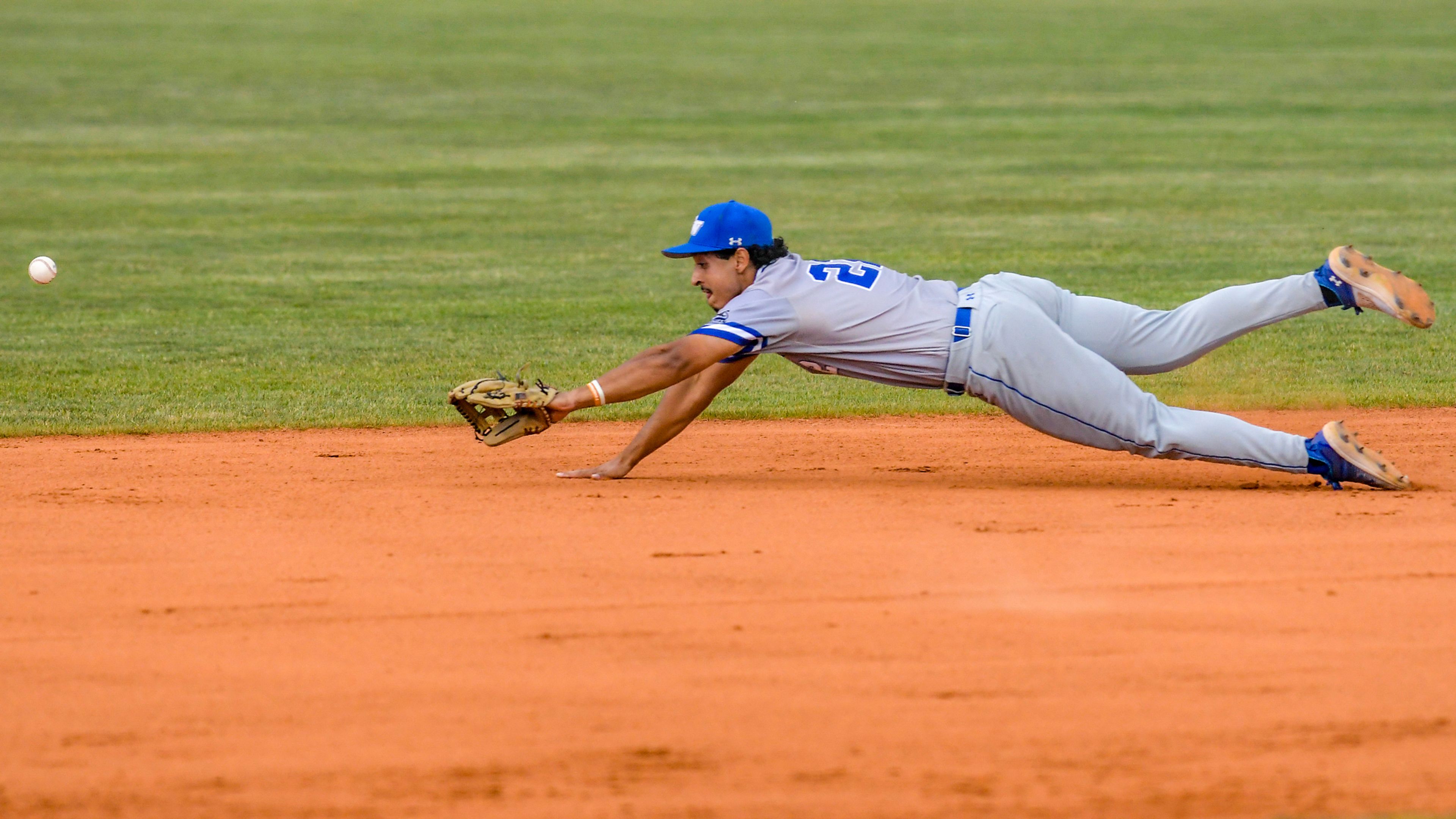 Tennessee Wesleyan shortstop Marco Martinez dives after a Cumberlands ground ball in an inning of game 3 of the NAIA World Series at Harris Field Friday in Lewiston.