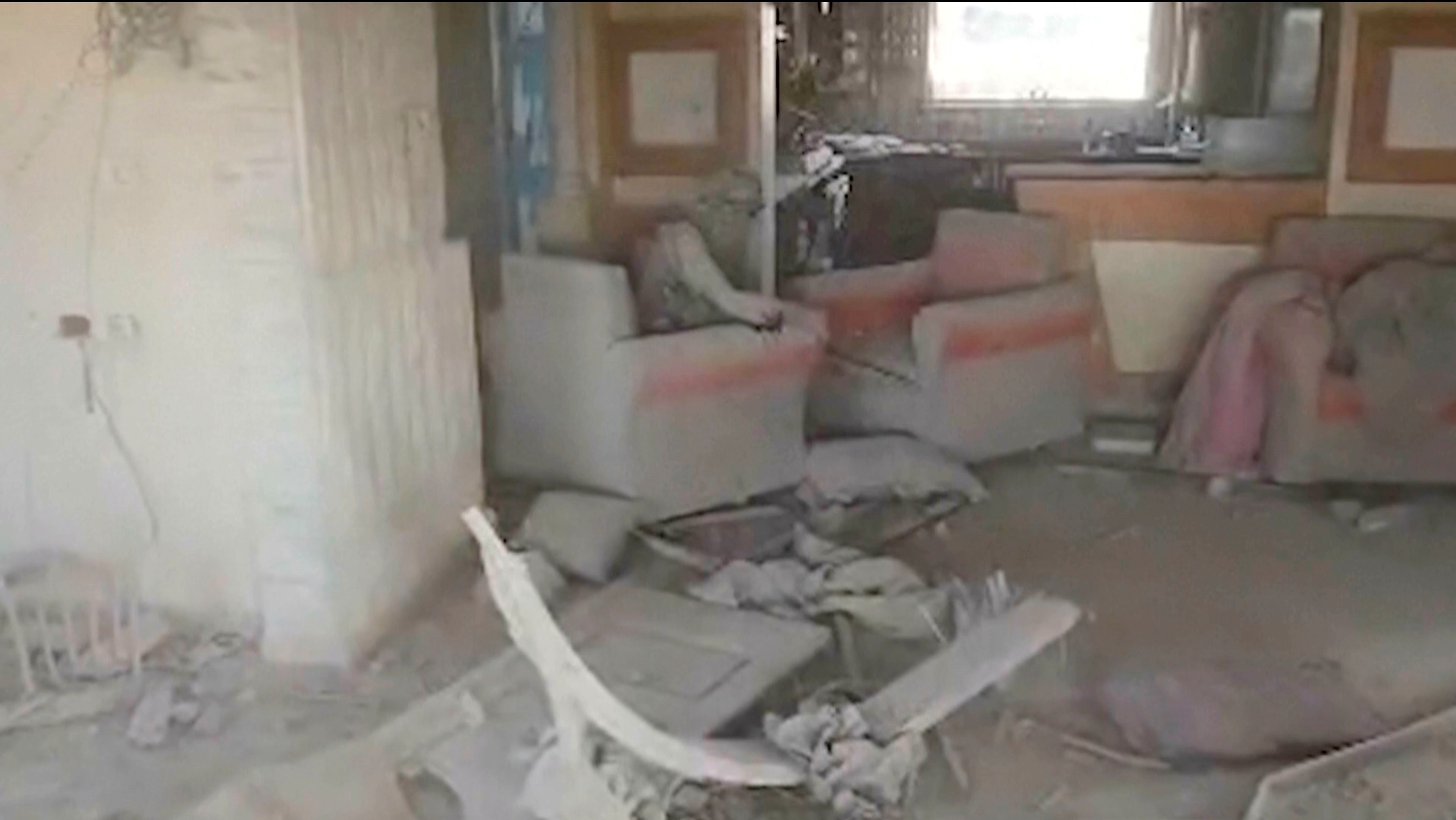 This still image from video provided by the Israel Defense Force (IDF) shows a heavily damaged building with a person the Israeli military identified as Hamas leader Yahya Sinwar seated in a chair in Rafah, Gaza Strip, on Wednesday, Oct. 16, 2024. (Israel Defense Force via AP)