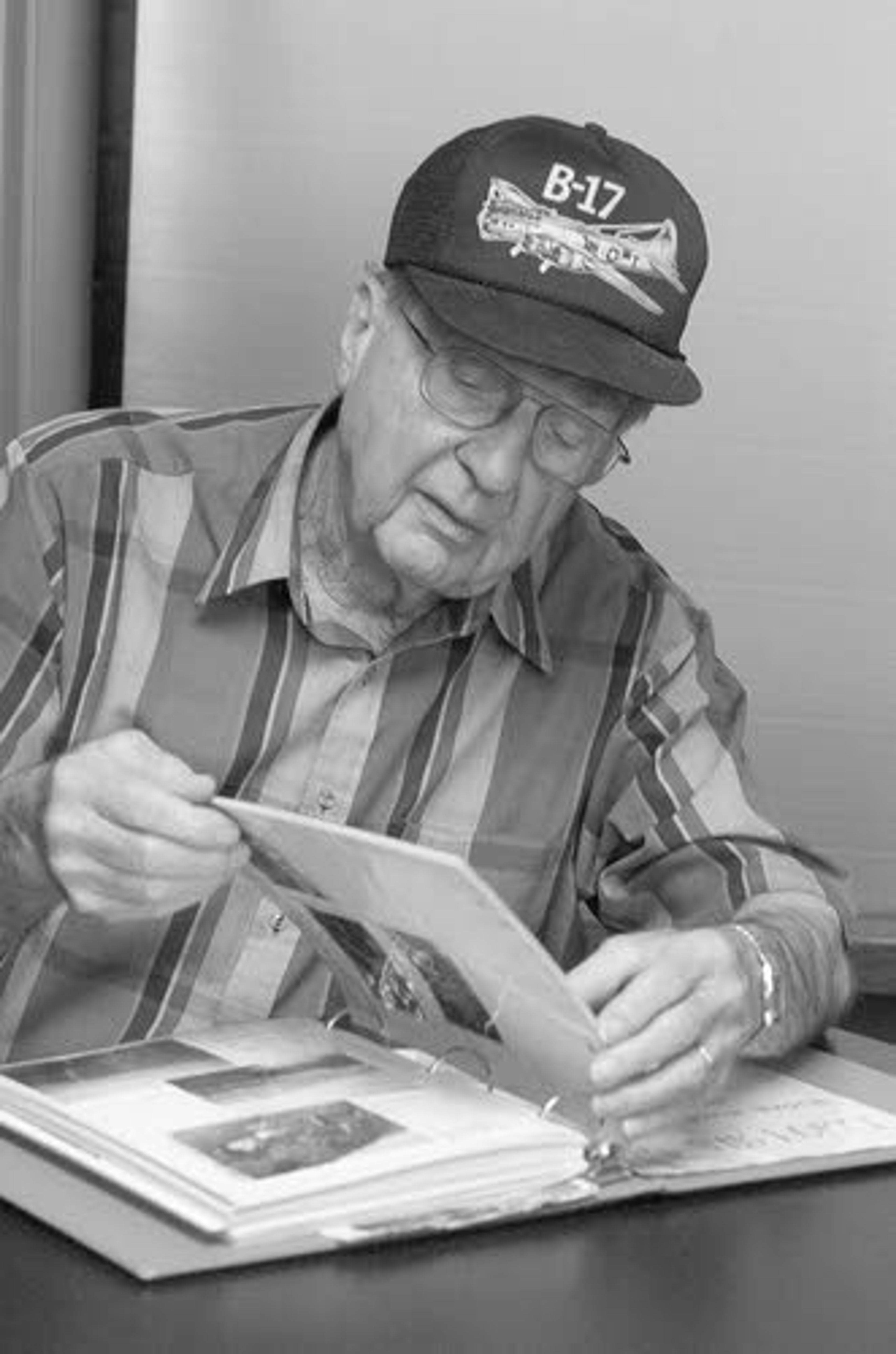 Gerald J. Druffel looks through a photo album.