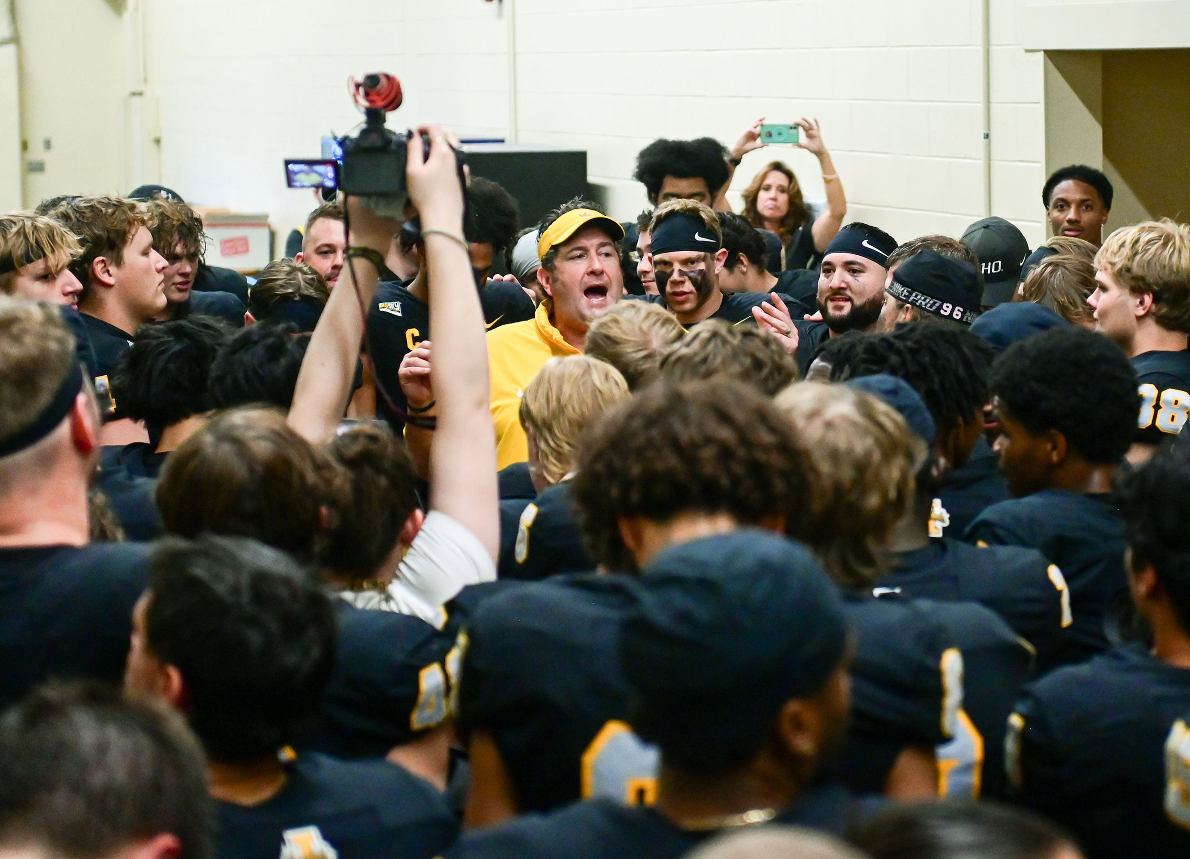 Idaho head coach Jason Eck congratulates the team in a post-game huddle after their homecoming weekend victory over Northern Arizona Saturday at the P1FCU Kibbie Dome in Moscow.,