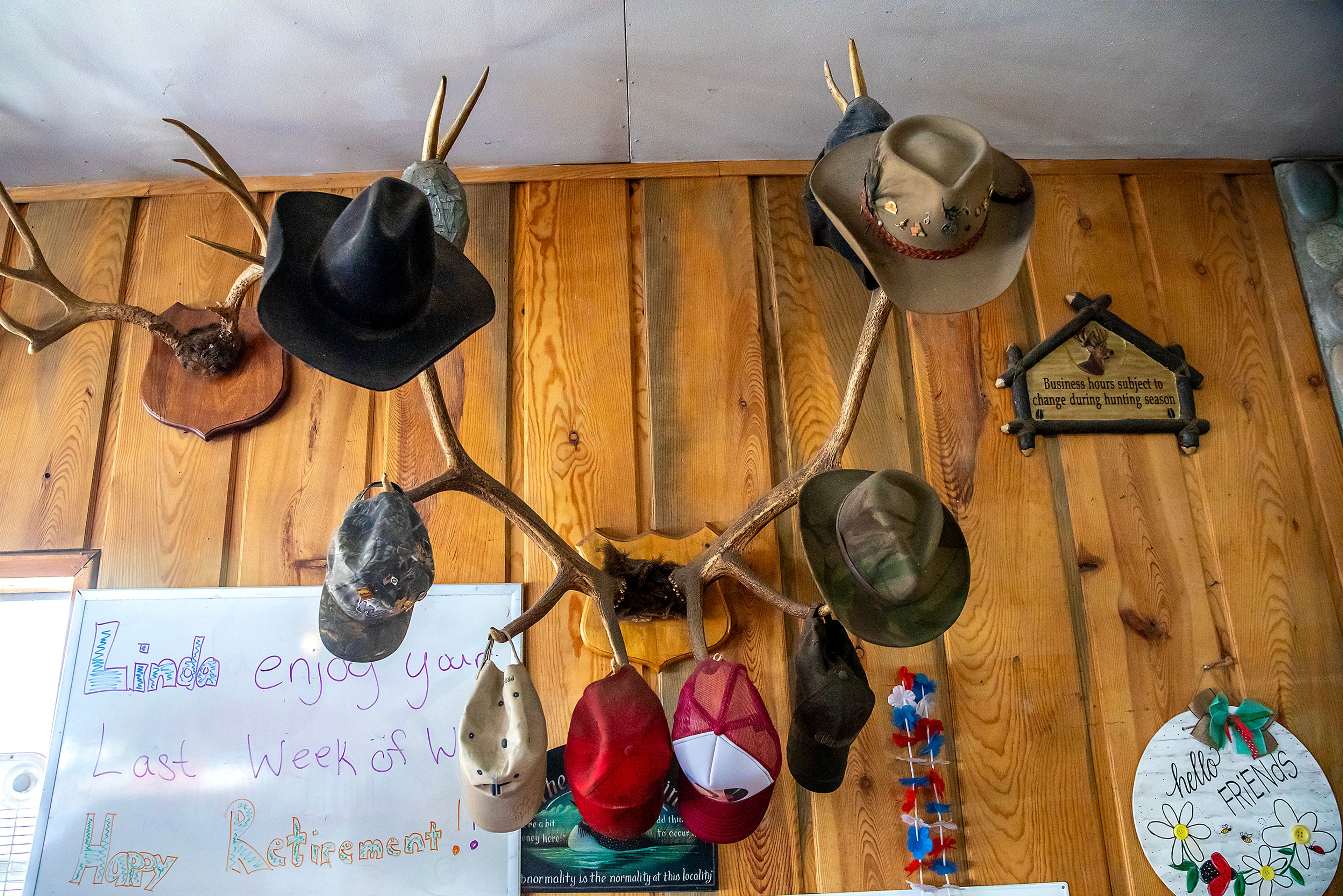 Hates hang on some antlers as a message on a whiteboard wishes Linda Elliott a happy retirement Thursday at the Keuterville Pub & Grub.