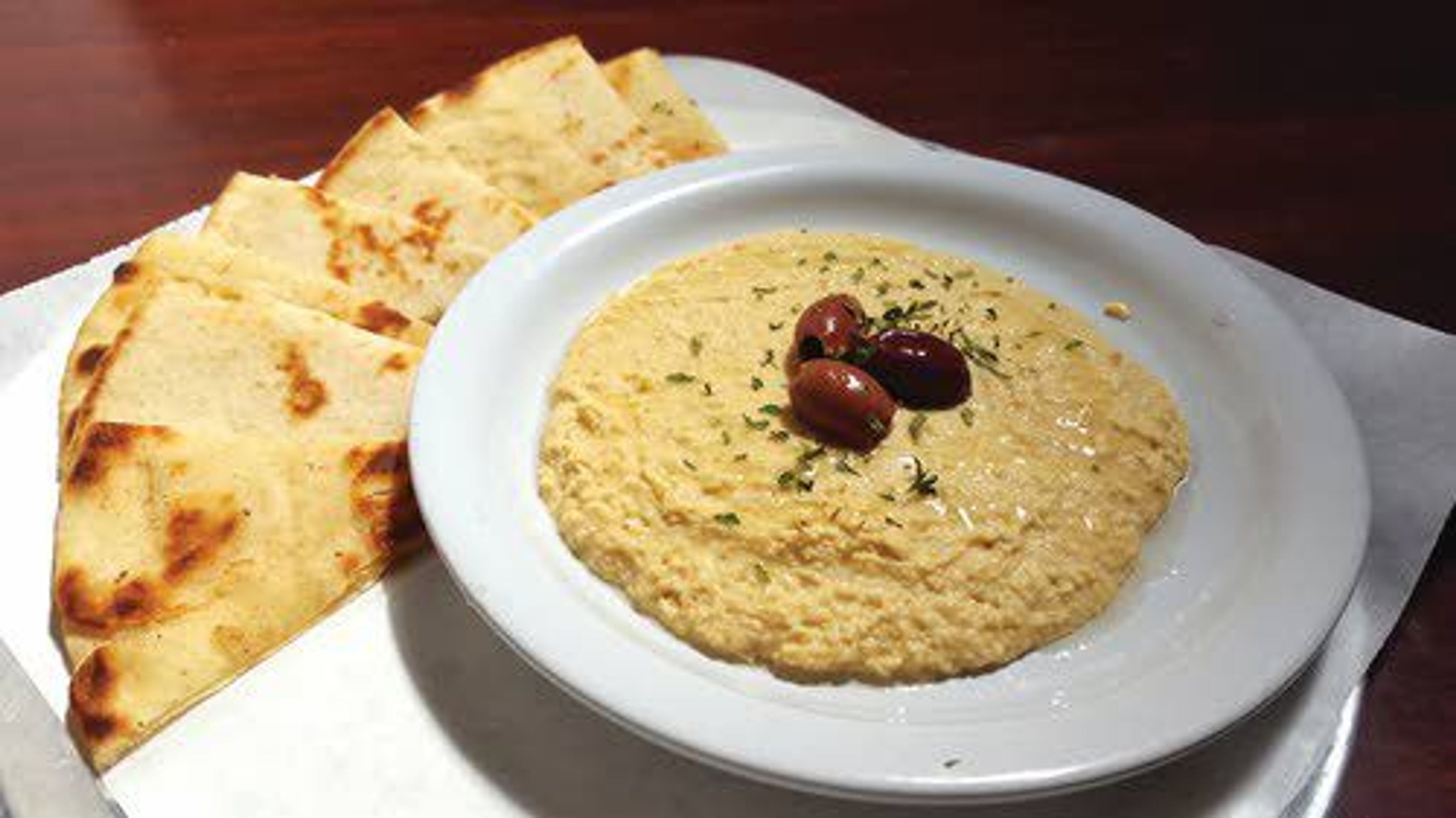 Mad Greek’s freshly made hummus dip with a side of pita.