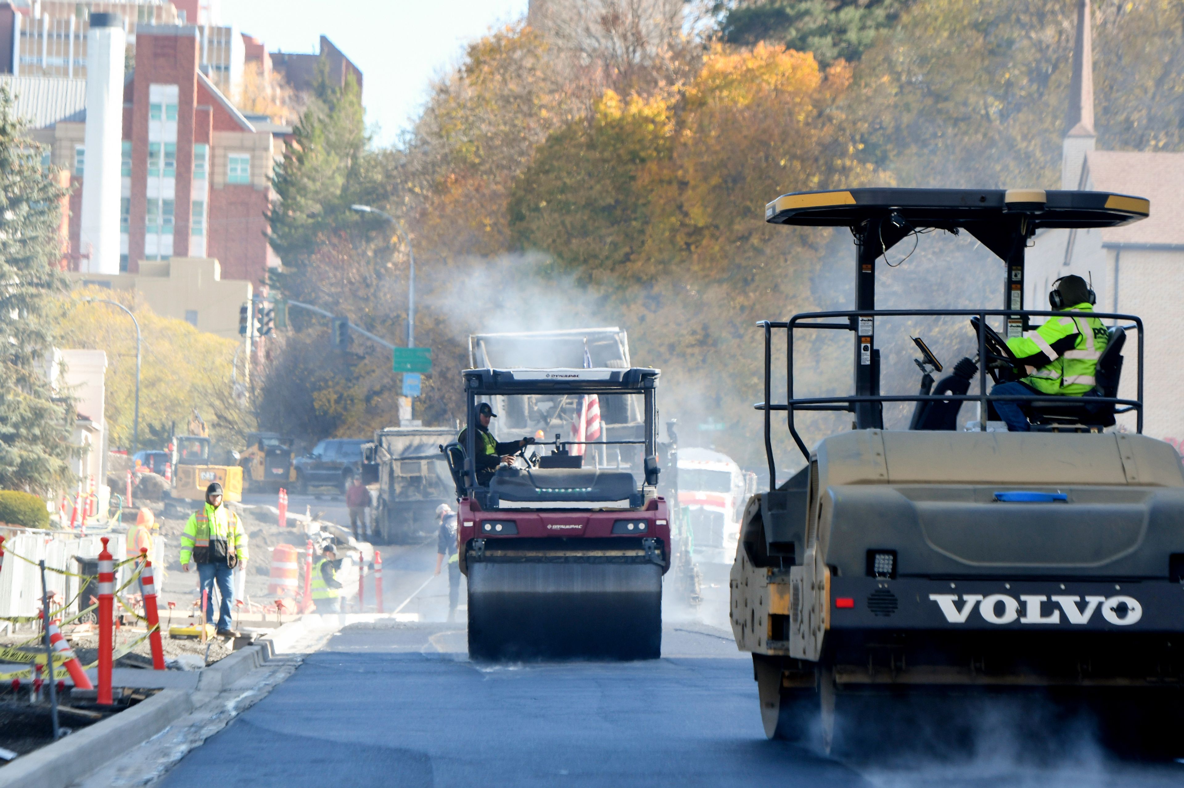 Rollers compact freshly laid asphalt Wednesday along Main Street in downtown Pullman.,