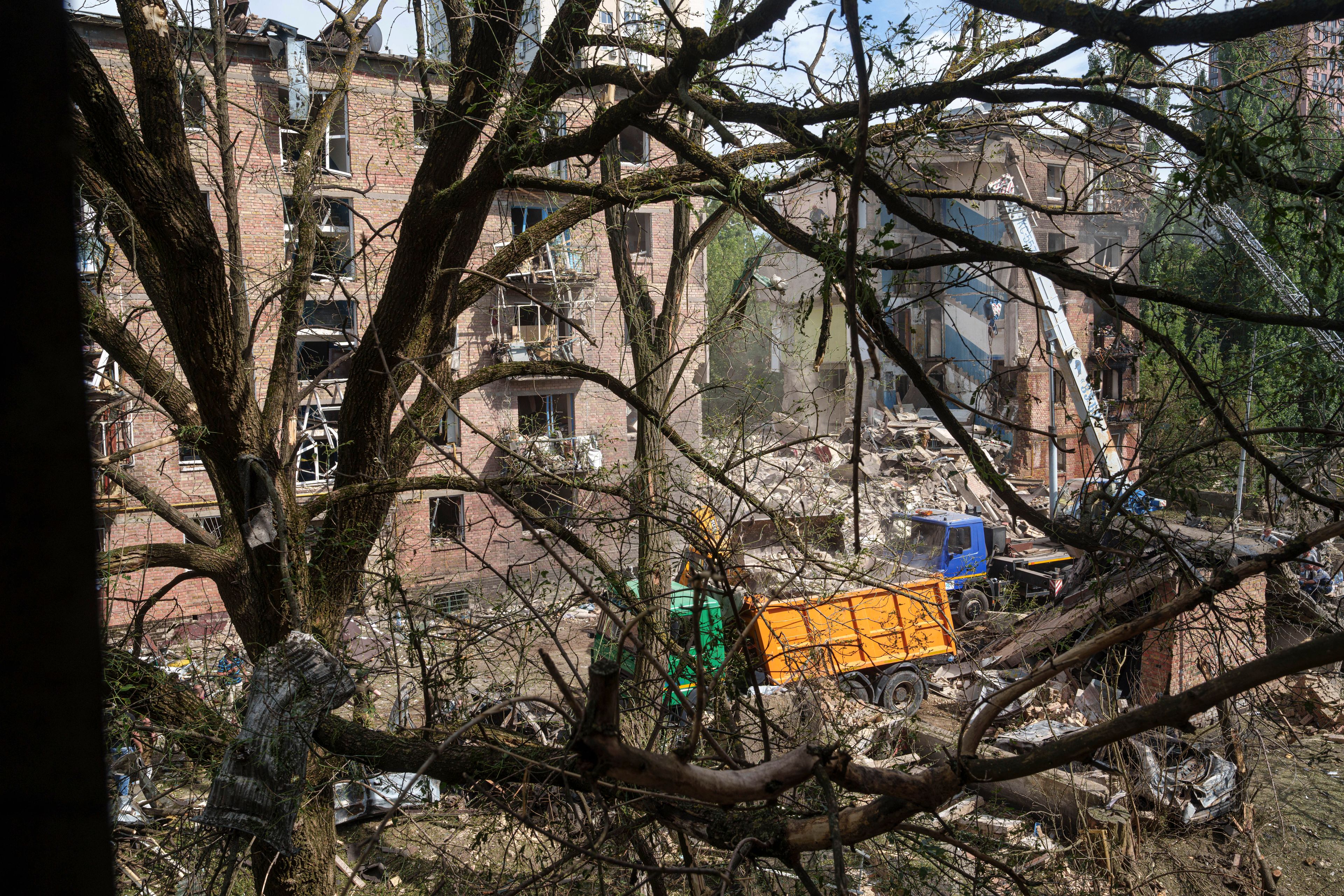 Rescuers clean up the rubble and search victims after Russian missile hit an apartment house in Kyiv, Ukraine, Monday, July 8, 2024. The daytime barrage targeted five Ukrainian cities with more than 40 missiles of different types hitting apartment buildings and public infrastructure, President Volodymyr Zelenskyy said on social media. (AP Photo/Evgeniy Maloletka)