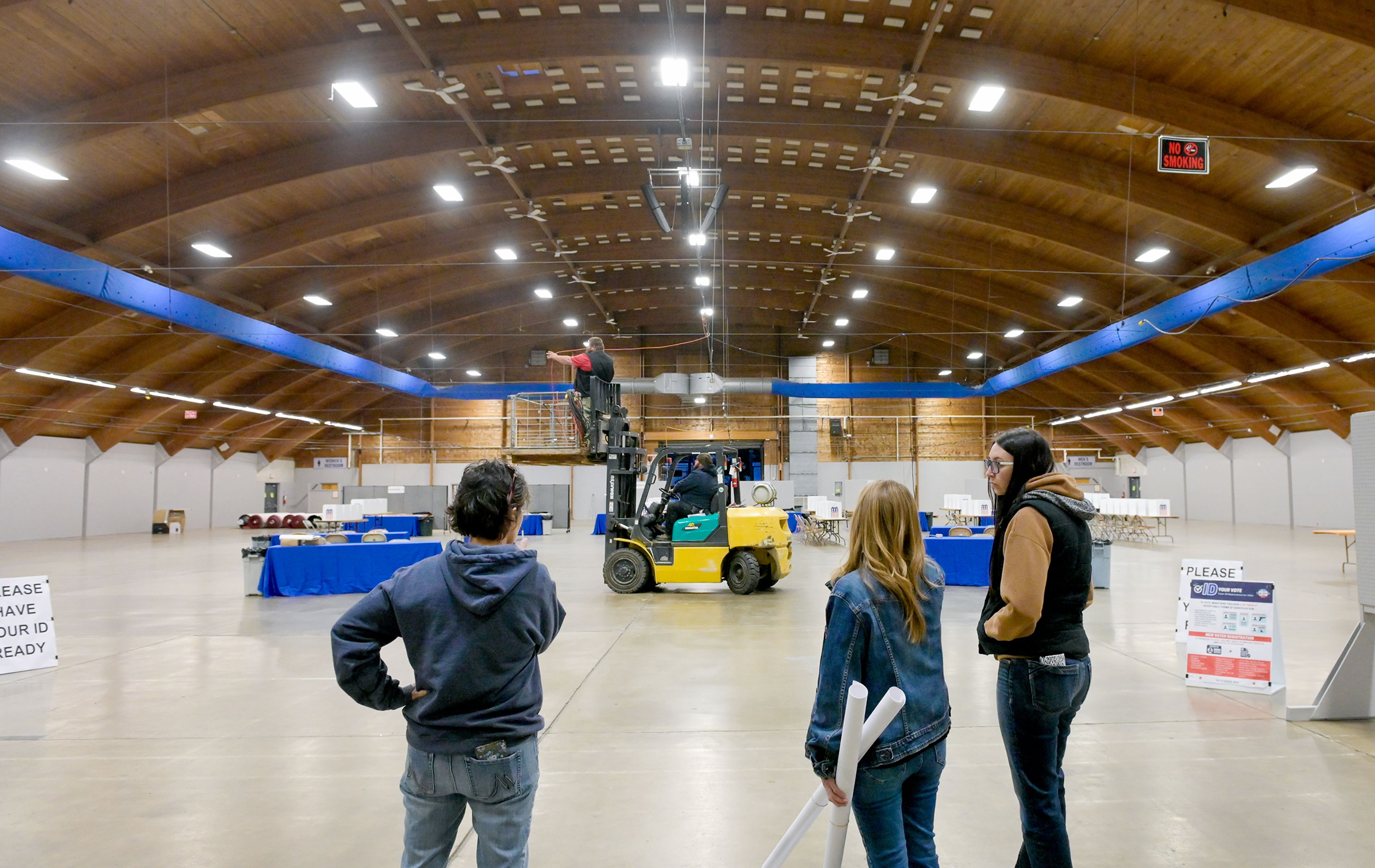 Amy Ledgerwood, left, Nez Perce County chief auditor, Patty Weeks, center, clerk and auditor, and Mckenzie Roberts, controller, look over the polling site at the Nez Perce County Fairgrounds Monday, making note of any adjustments needed before Election Day in Lewiston.