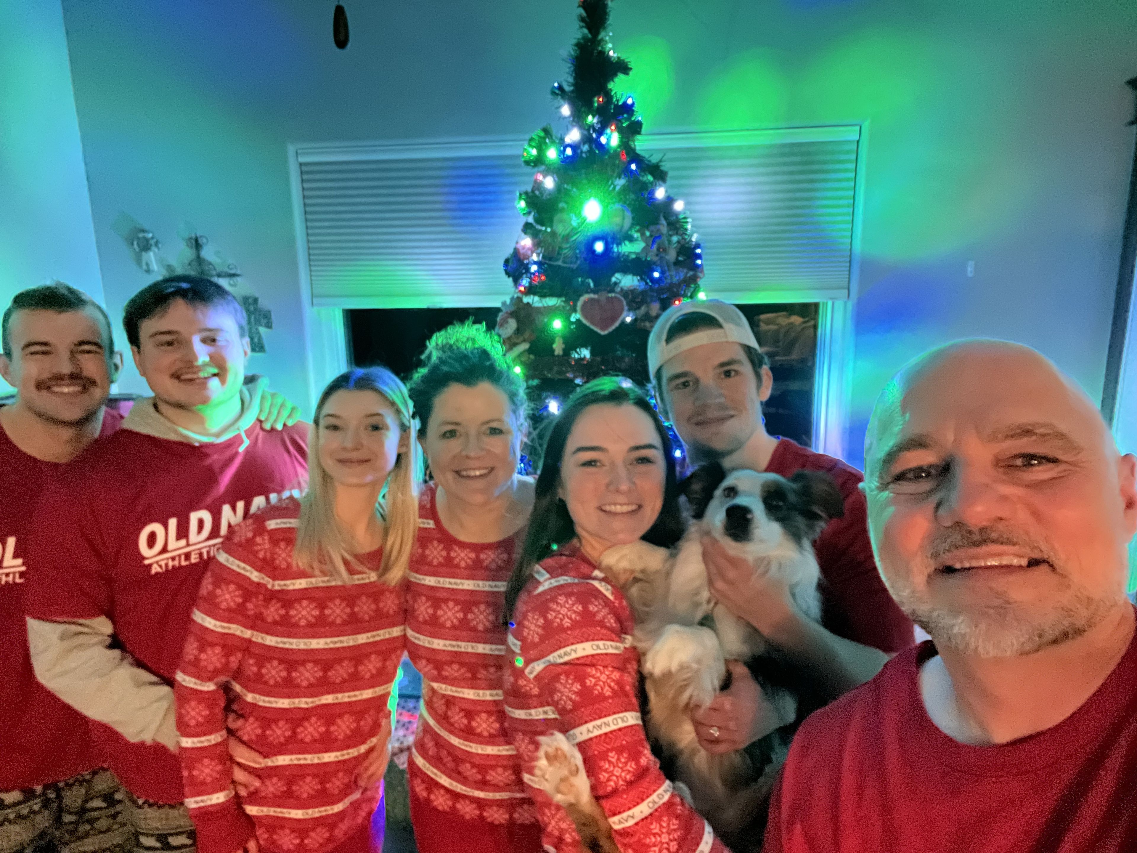 Robin Lund and his family, from left, sons Brett and Sam, Sam’s girlfriend Cileigh, wife Susie Lund, daughter Abbie and her husband Keaten, pose for a photo on Christmas, 2024, at the Lund family home in Iowa City.