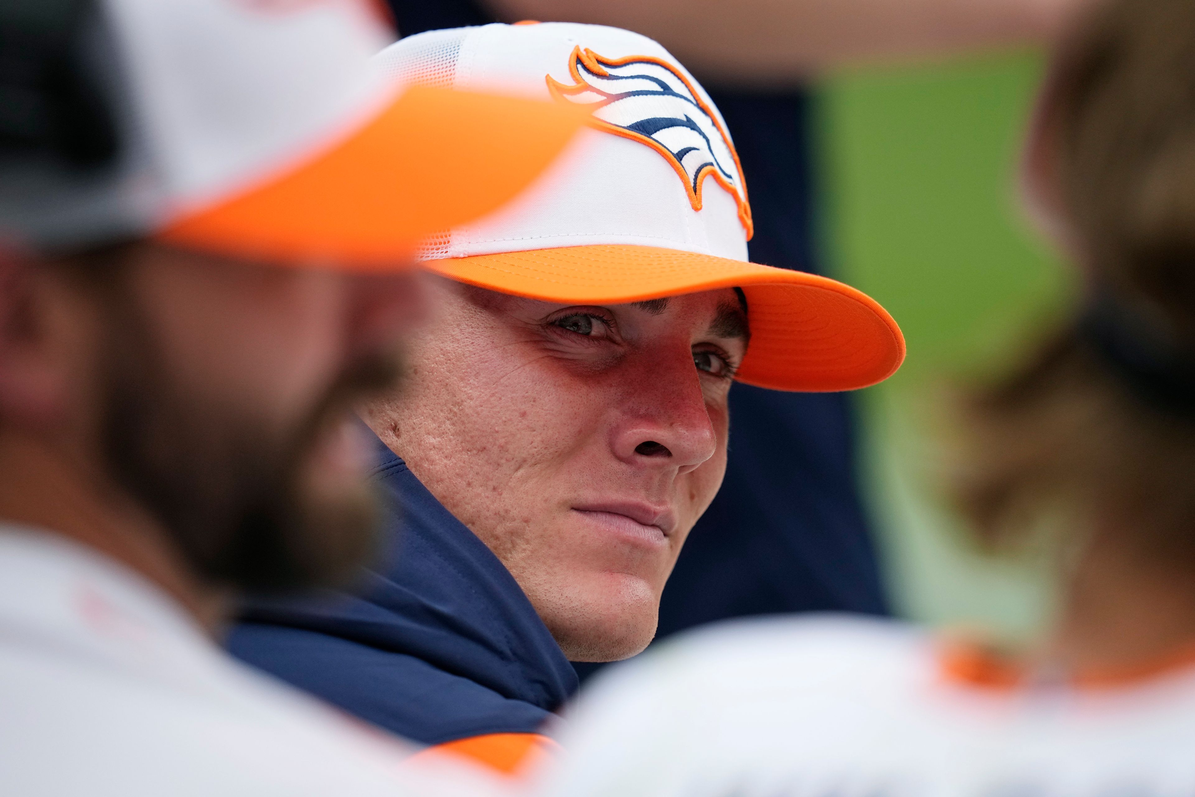 Denver Broncos quarterback Bo Nix sits on the team bench during the second half of a preseason NFL football game against the Arizona Cardinals, Sunday, Aug. 25, 2024, in Denver. (AP Photo/Jack Dempsey)