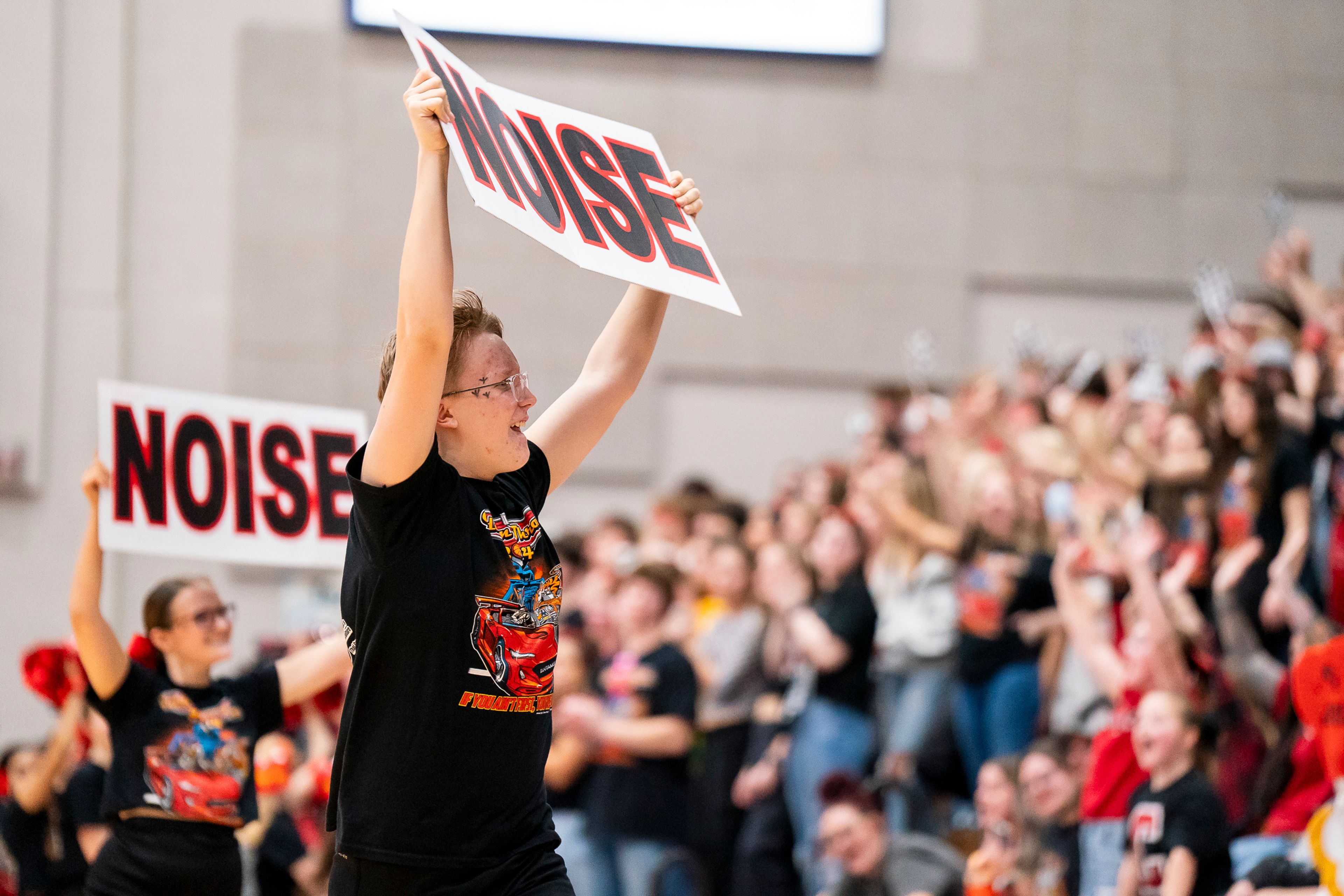 Clarkston High School students raise “Noise” signs during a timeout during the girls basketball Golden Throne rivalry game against Lewiston on Friday inside the P1FCU Activity Center in Lewiston.